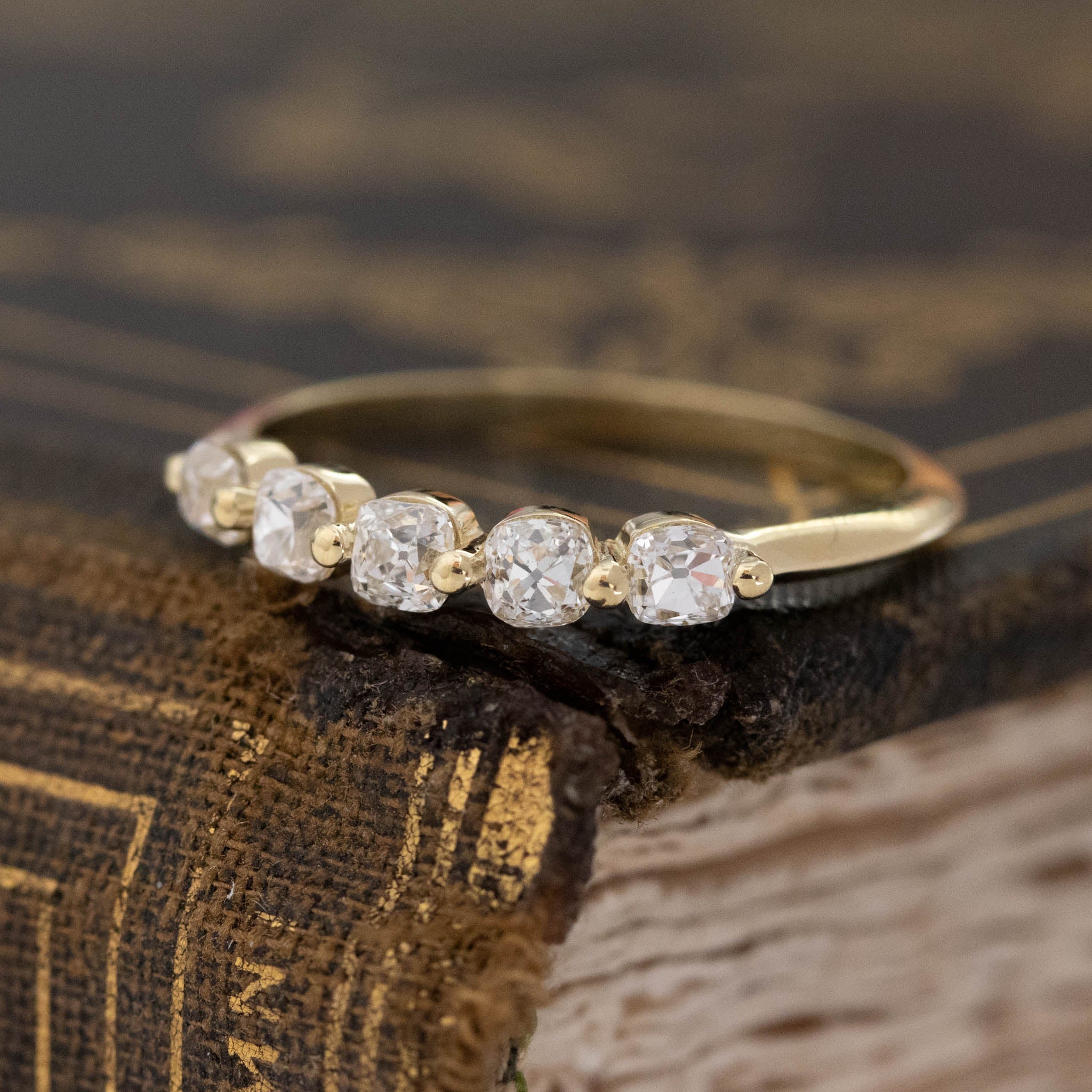 Antique lovers’ .58ctw Petite Old Mine Cut Diamond Shared Prong Band in yellow gold, featuring rare Earth-mined Old Mine Cut Diamonds.
