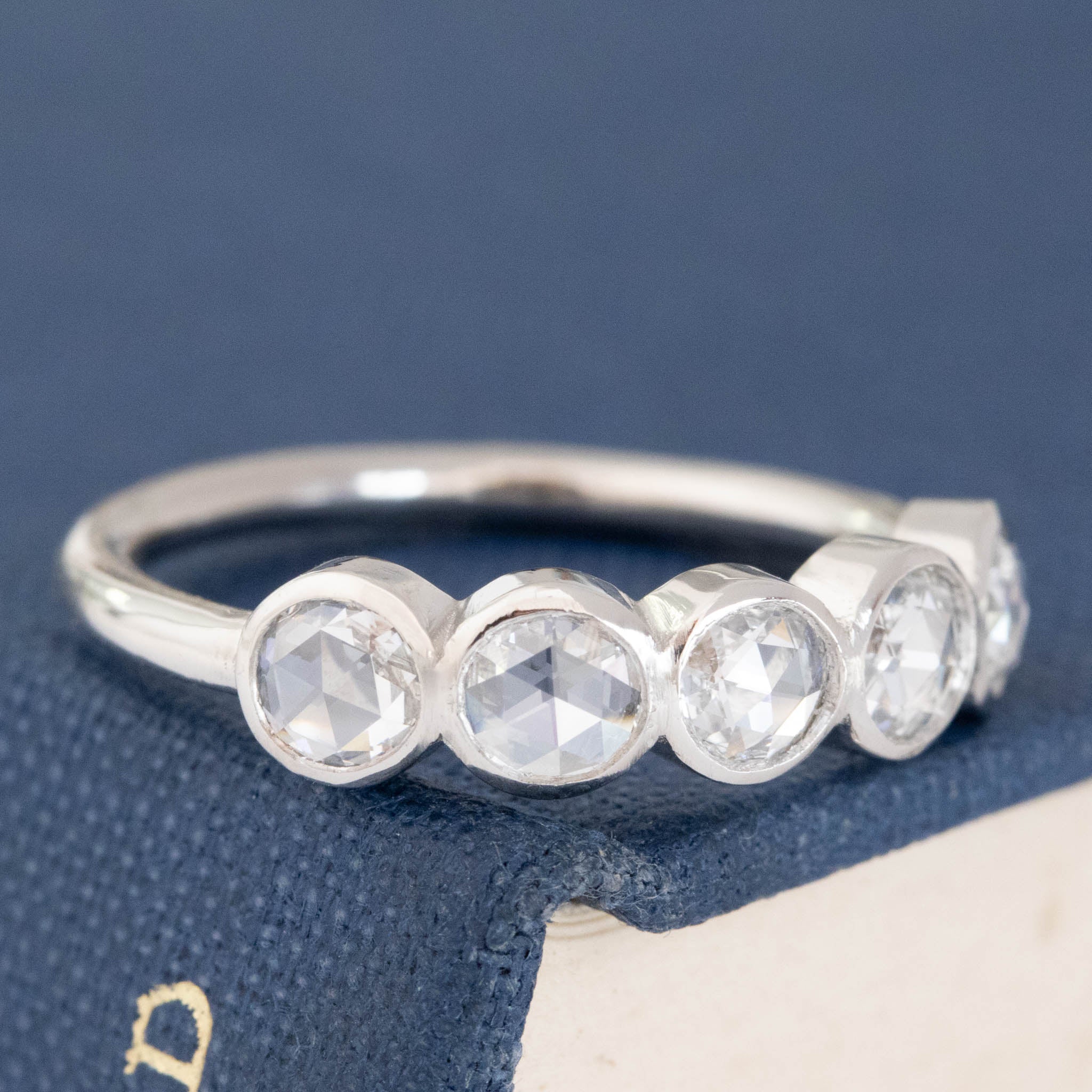 Close-up of .59ctw Round Rose Cut Diamond 5-Stone Bezel Band, vintage-inspired band with Antique Diamonds, crafted in platinum.