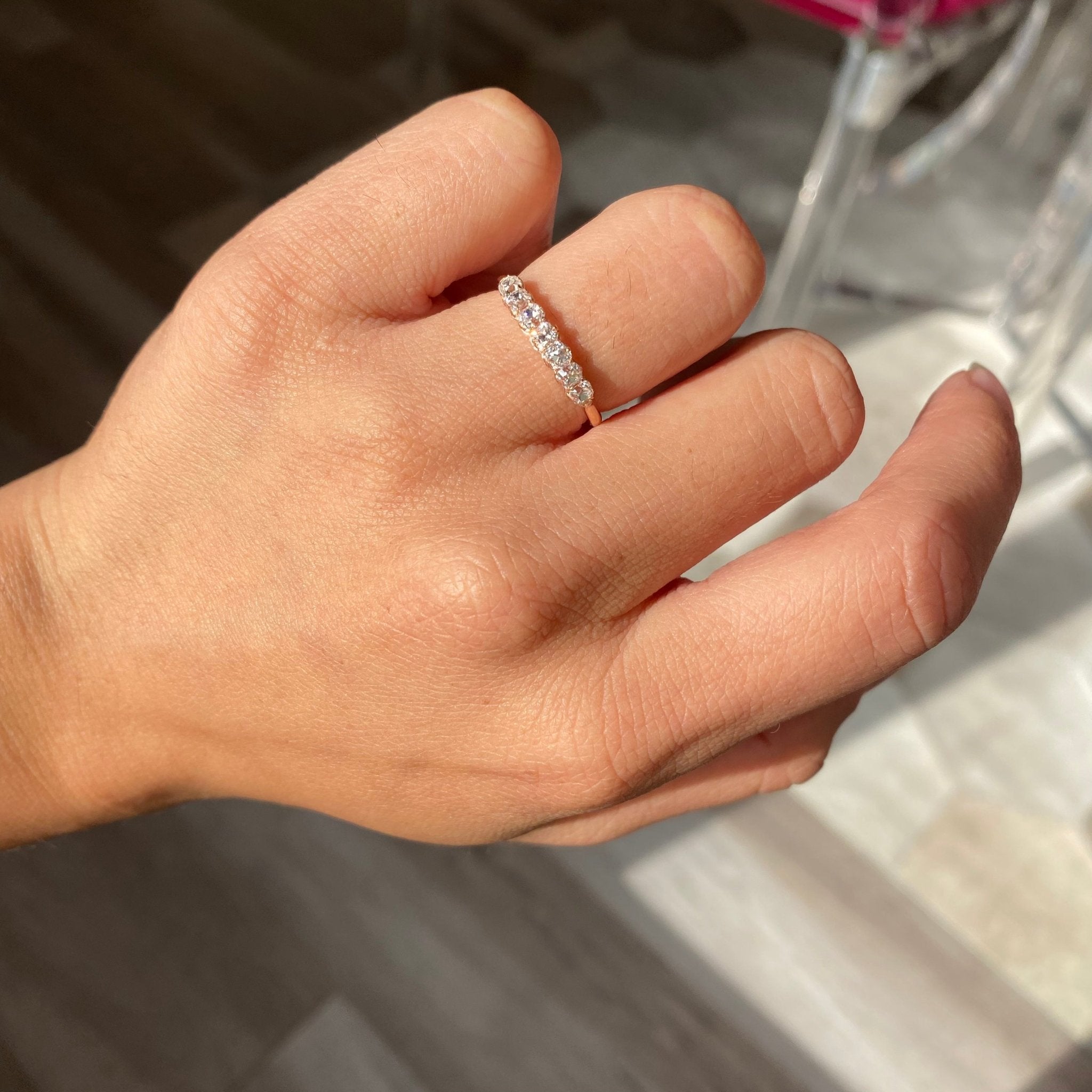 Elegant .60ctw Petite Old Mine Cut 7-Stone Diamond Band, romantic design with Old Mine Cut Diamonds, Earth-mined diamonds in rose gold shown on ring finger.