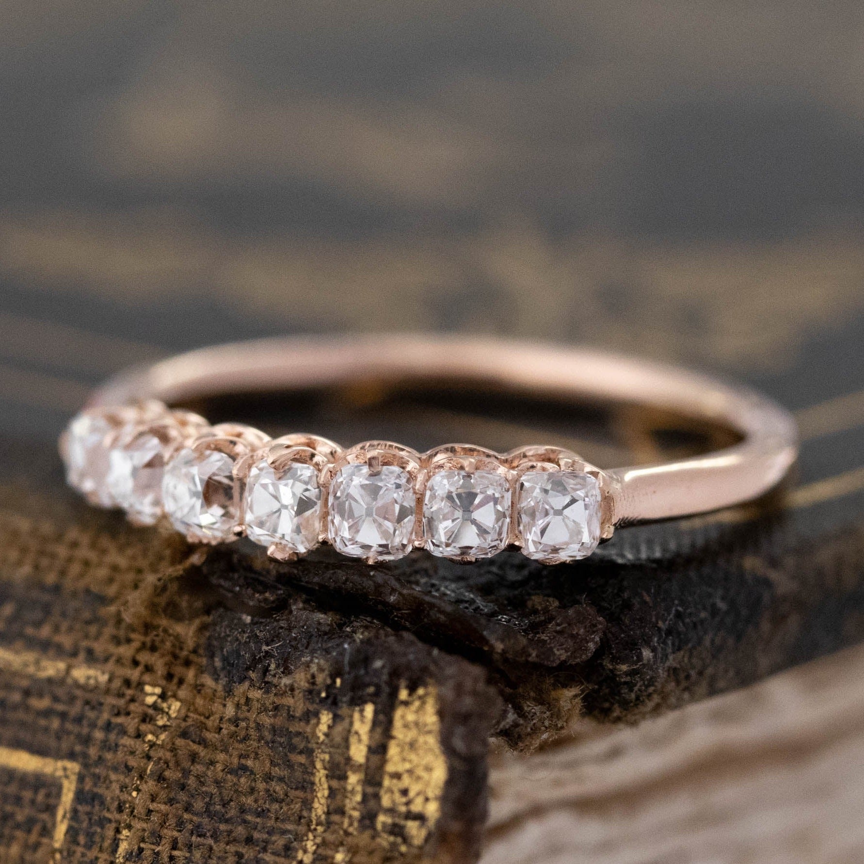 Close-up of .60ctw Petite Old Mine Cut 7-Stone Diamond Band, vintage-inspired band with Old Mine Cut Diamonds, crafted in rose gold.