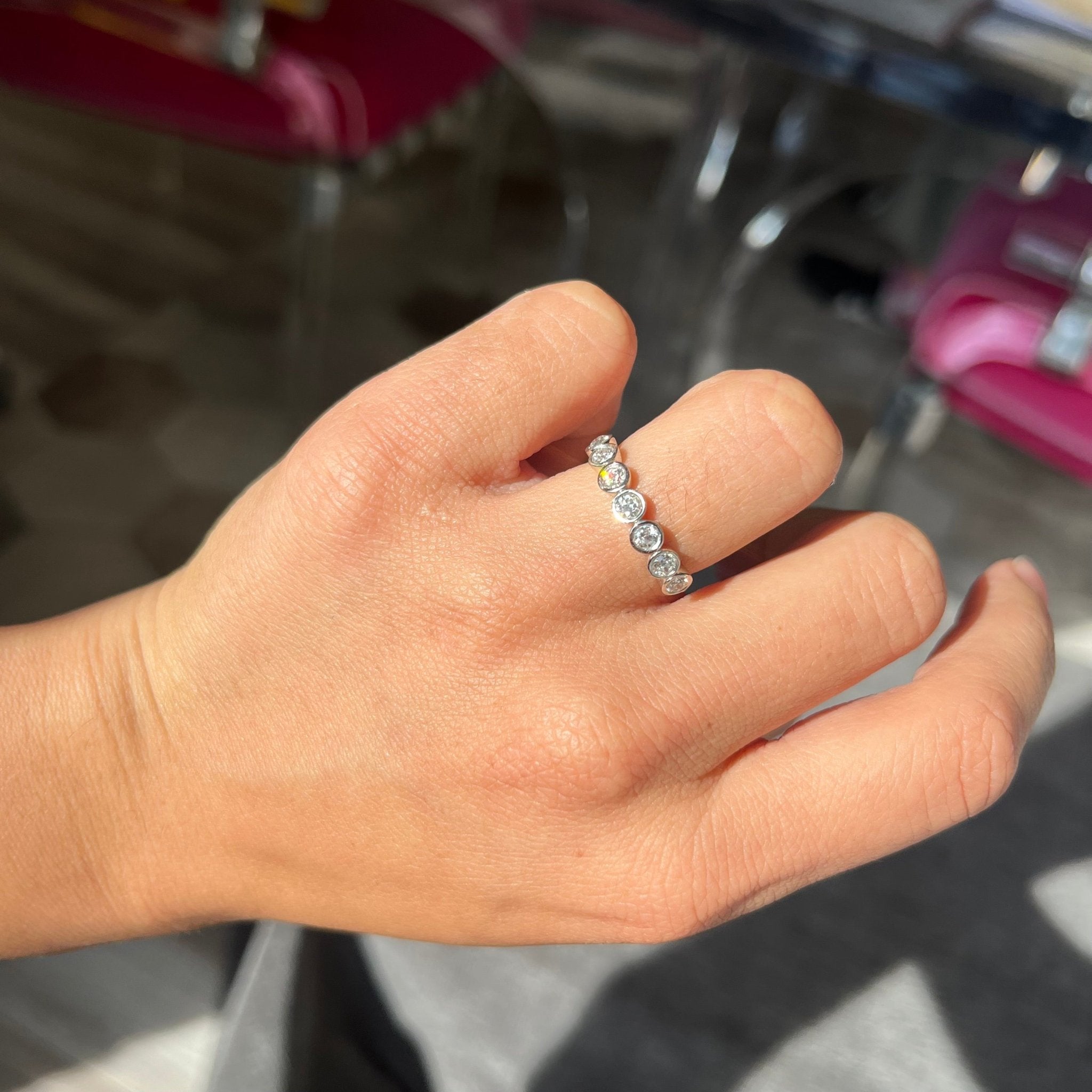Elegant .62ctw Old European Cut Diamond 7-Stone Bezel Band, romantic design with Old European Cut Diamonds, Earth-mined diamonds in platinum shown on ring finger