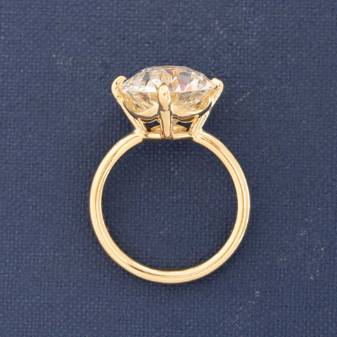 Side view of 6.5ct Old European diamond ring in four-prong compass setting.