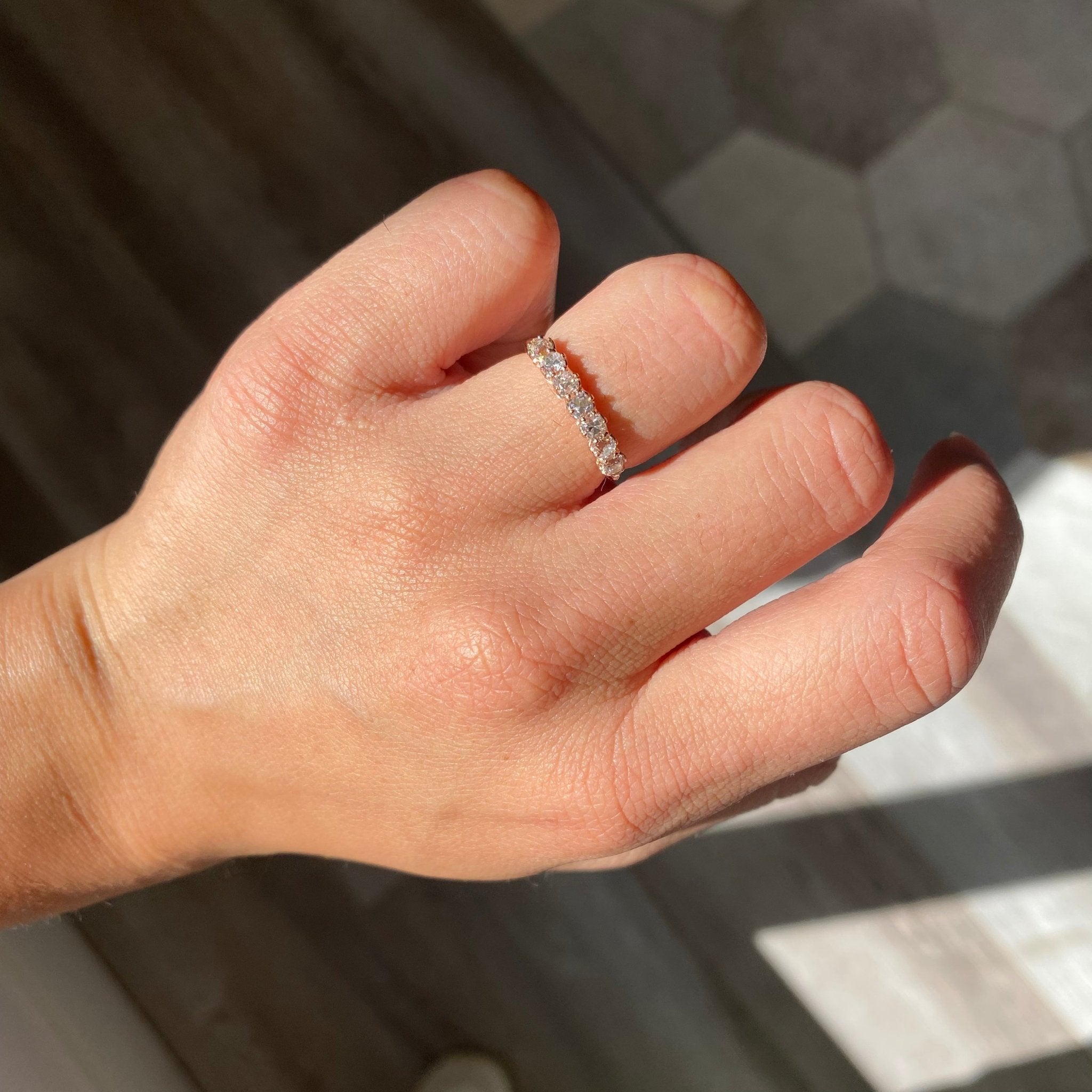Elegant .65ctw Petite Old Mine Cut Diamond 7-Stone Band, romantic design with Old Mine Cut Diamonds, Earth-mined diamonds in rose gold shown on ring finger