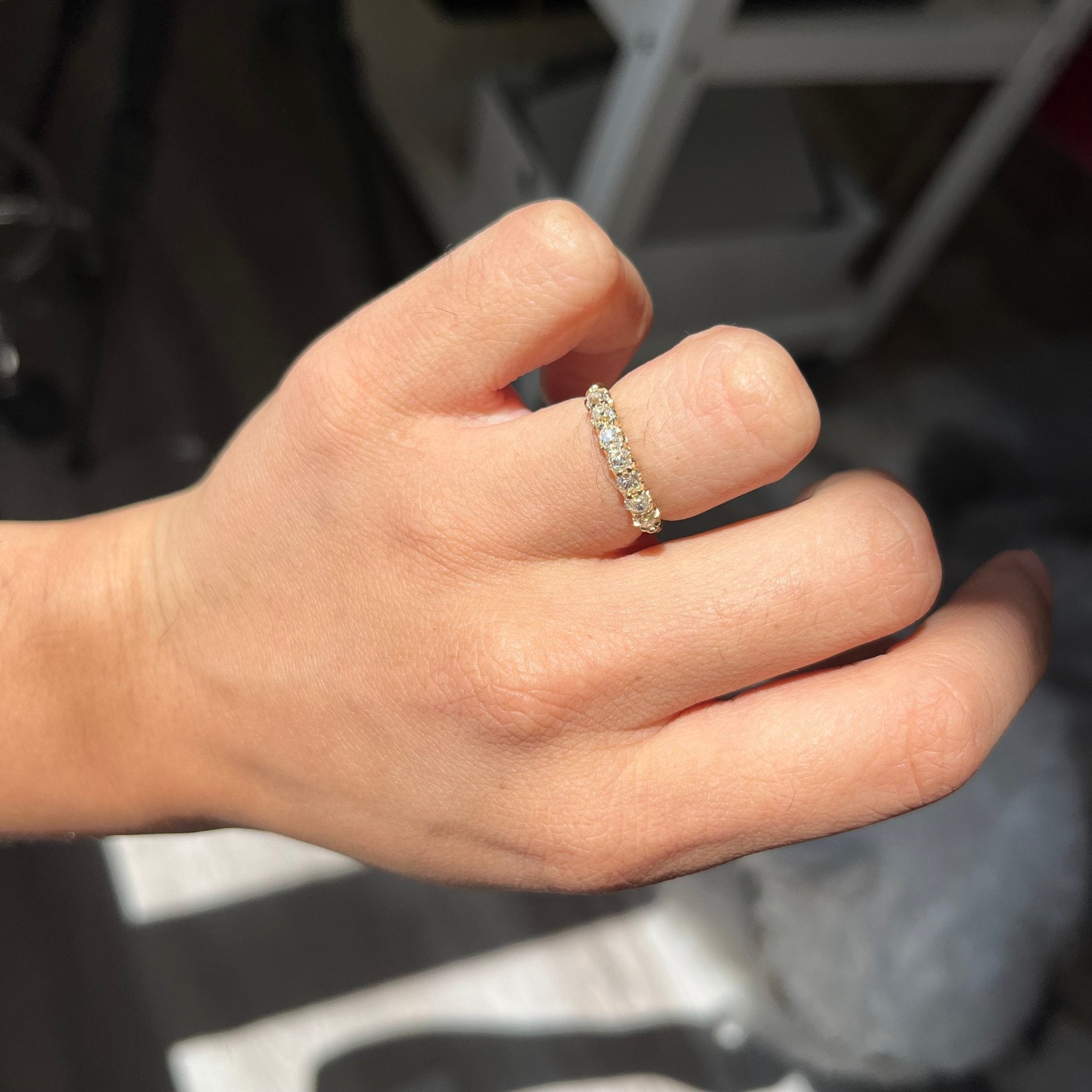 Elegant .66ctw Petite Old Mine Cut Diamond Half-Hoop Band, romantic design with Old Mine Cut Diamonds, Earth-mined diamonds in yellow gold shown on ring finger