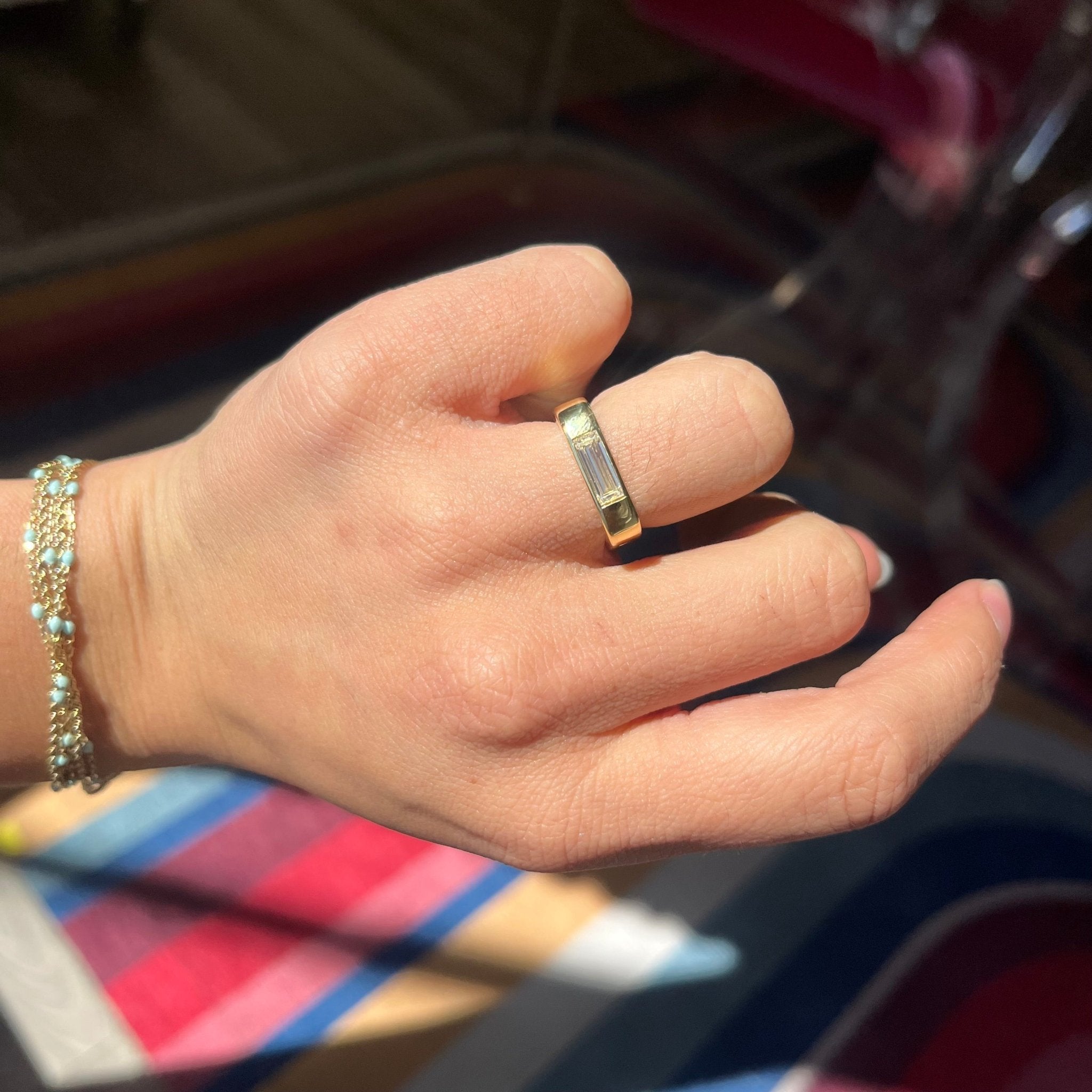 Elegant .67ct Baguette Cut Diamond Square Shank Band, romantic design with Baguette Cut Diamonds, Earth-mined diamonds in yellow gold shown on ring figner