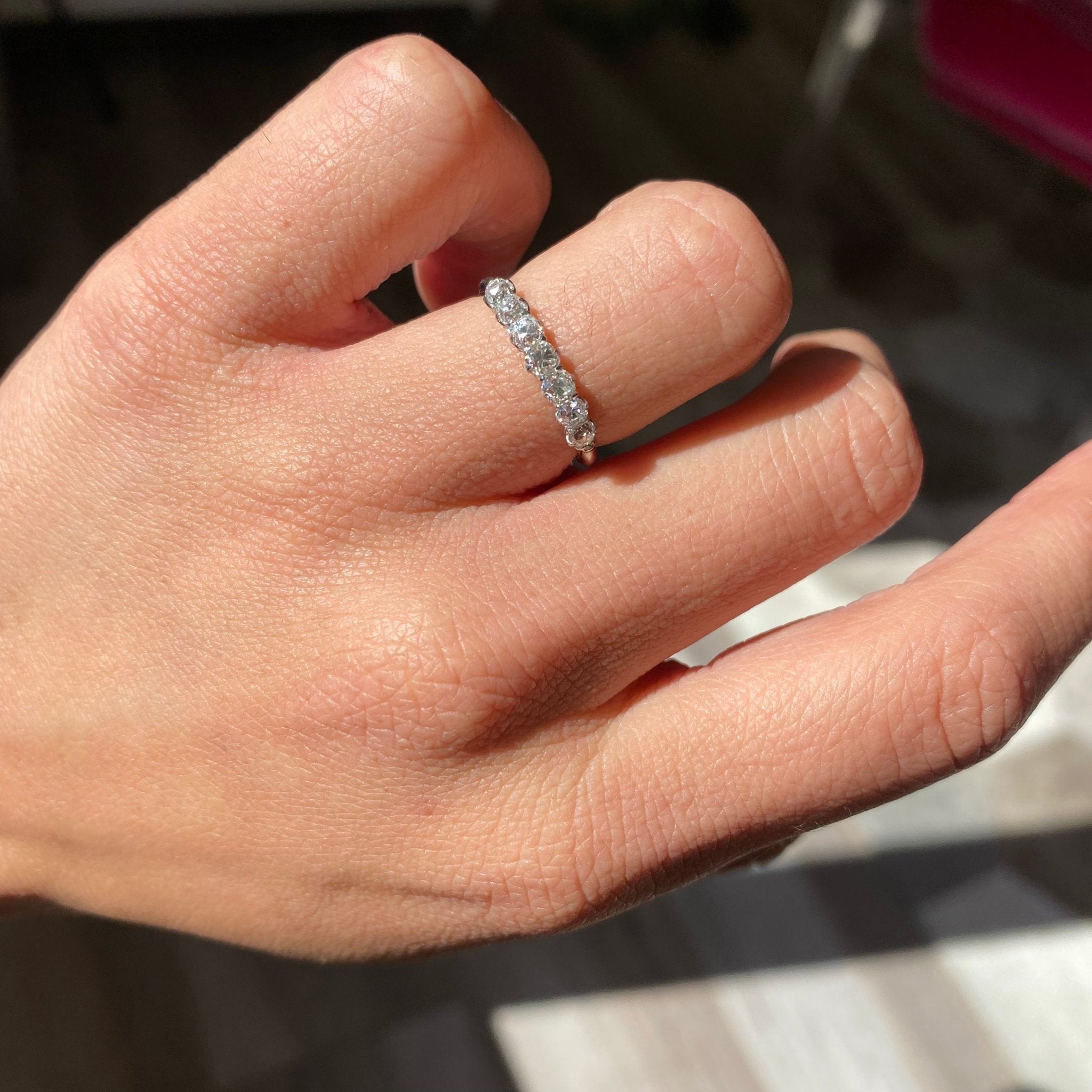 Elegant .68ctw Petite Old Mine Cut Diamond 7-Stone Band, romantic design with Old Mine Cut Diamonds, Earth-mined diamonds in platinum shown on ring finger