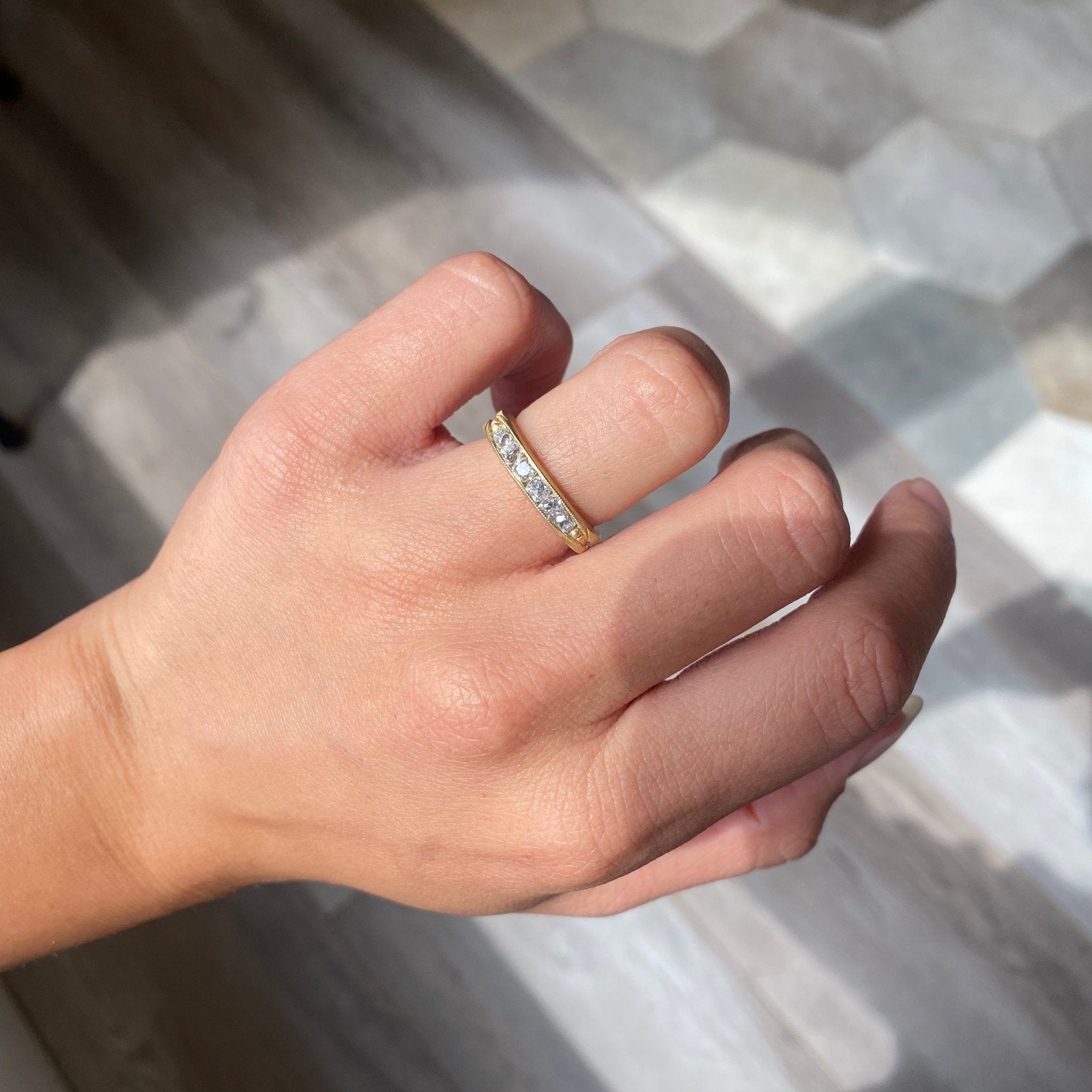 Elegant .69ctw Channel Set Old Mine Cut Diamond Band, romantic design with Old Mine Cut Diamonds, Earth-mined diamonds in yellow gold shown on ring finger