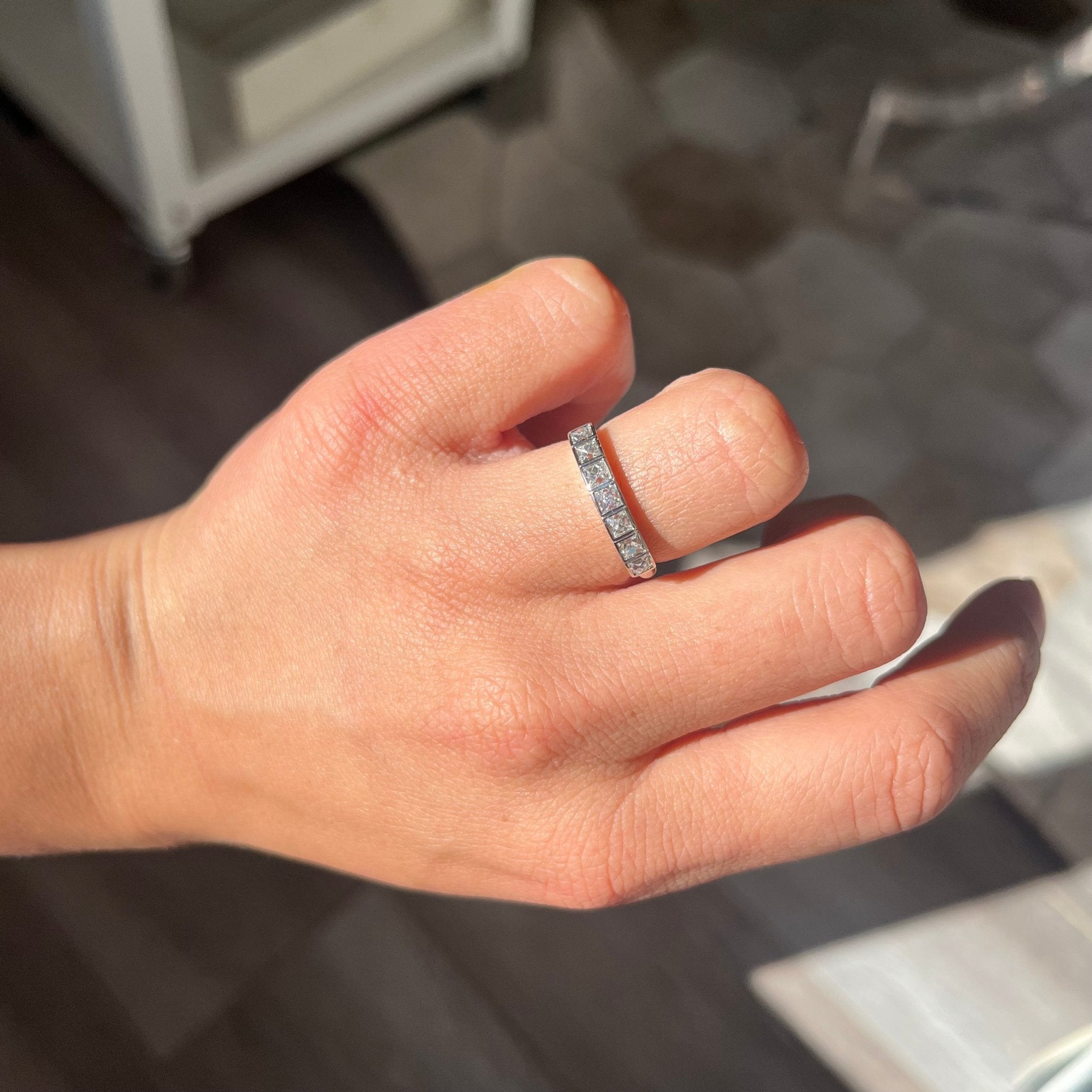 Elegant .70ctw French Cut Diamond Half-Hoop Bezel Band, romantic design with French Cut Diamonds, Earth-mined diamonds in platinum shown on ring finger