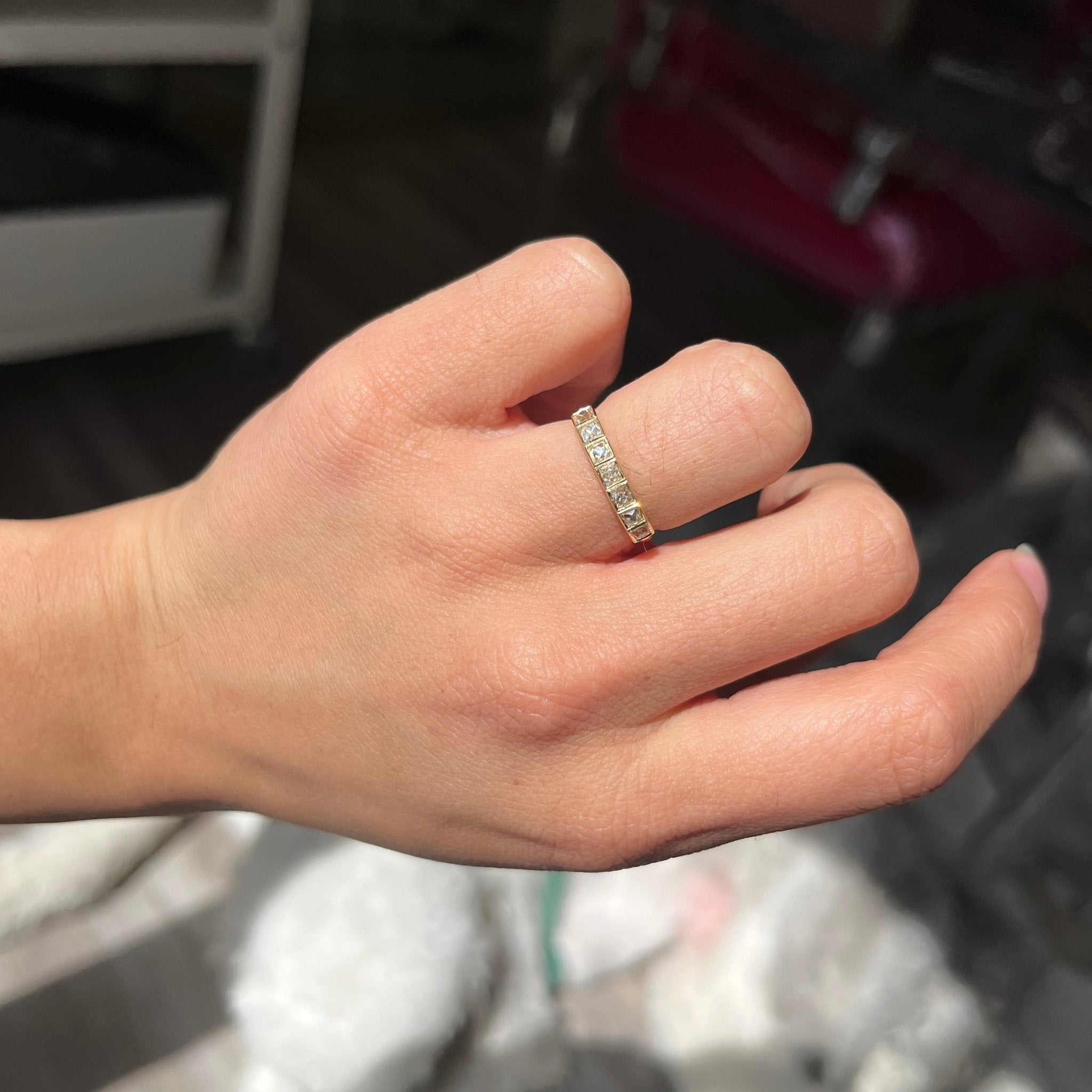 Elegant .71ctw French Cut Diamond Bezel Band, romantic design with French Cut Diamonds, Earth-mined diamonds in yellow gold shown on ring finger