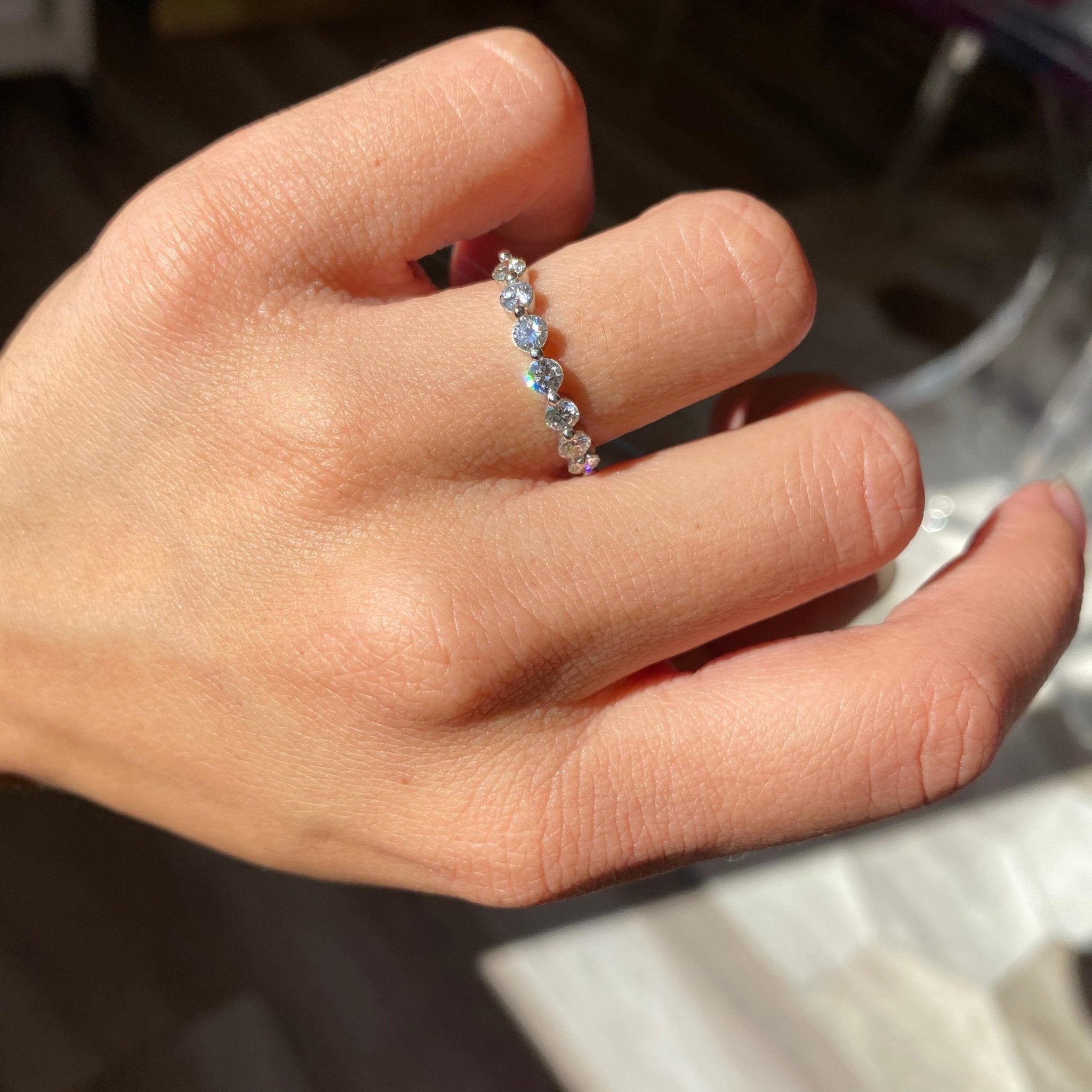 Elegant .74ctw Round Brilliant Cut Diamond Shared-Prong Band, romantic design with Antique Diamonds, Earth-mined diamonds in platinum shown on ring finger