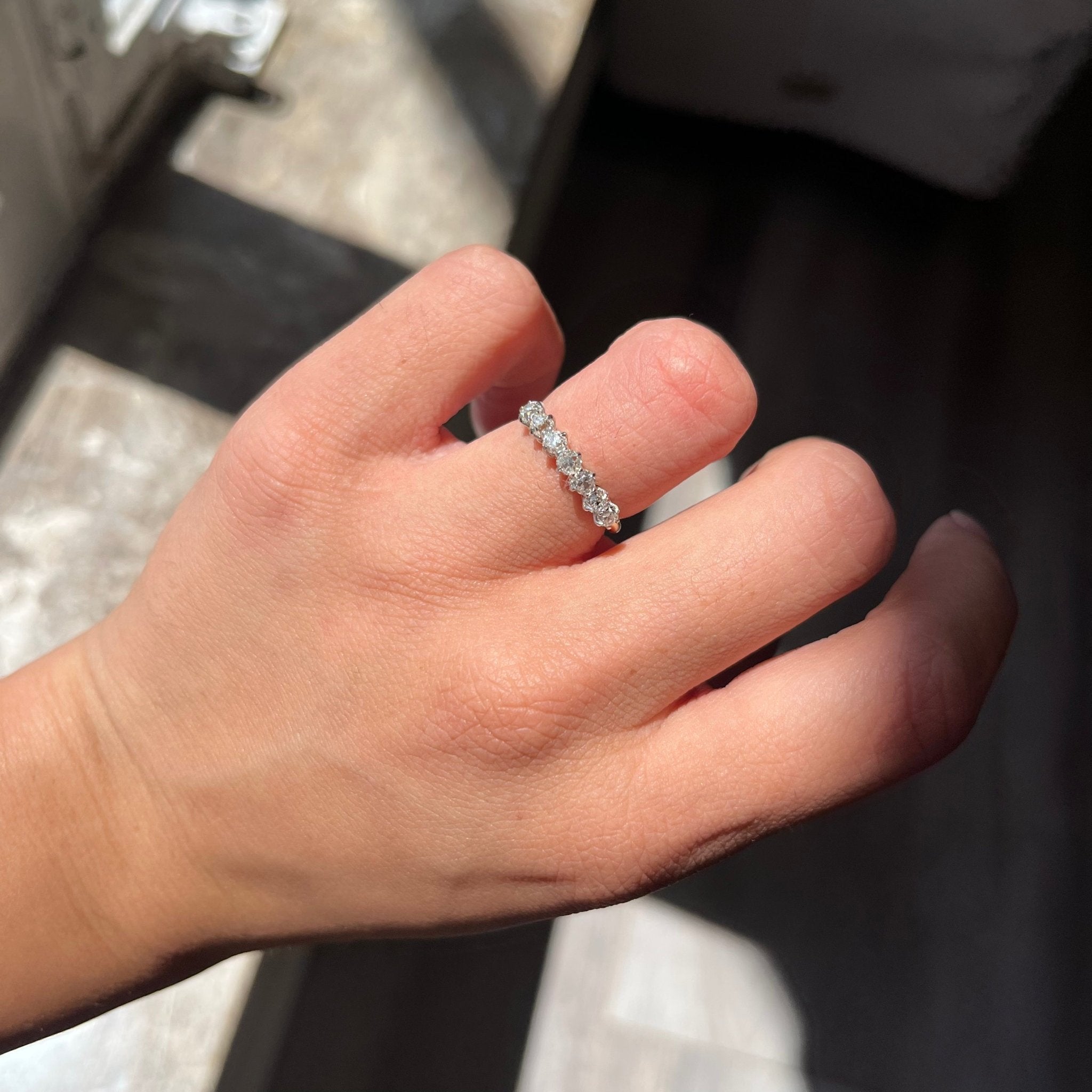 Elegant .75ctw Old Mine Cut Diamond 7-Stone Half-Hoop Band, romantic design with Old Mine Cut Diamonds, Earth-mined diamonds with a platinum gallery and yellow gold shank shown on ring finger