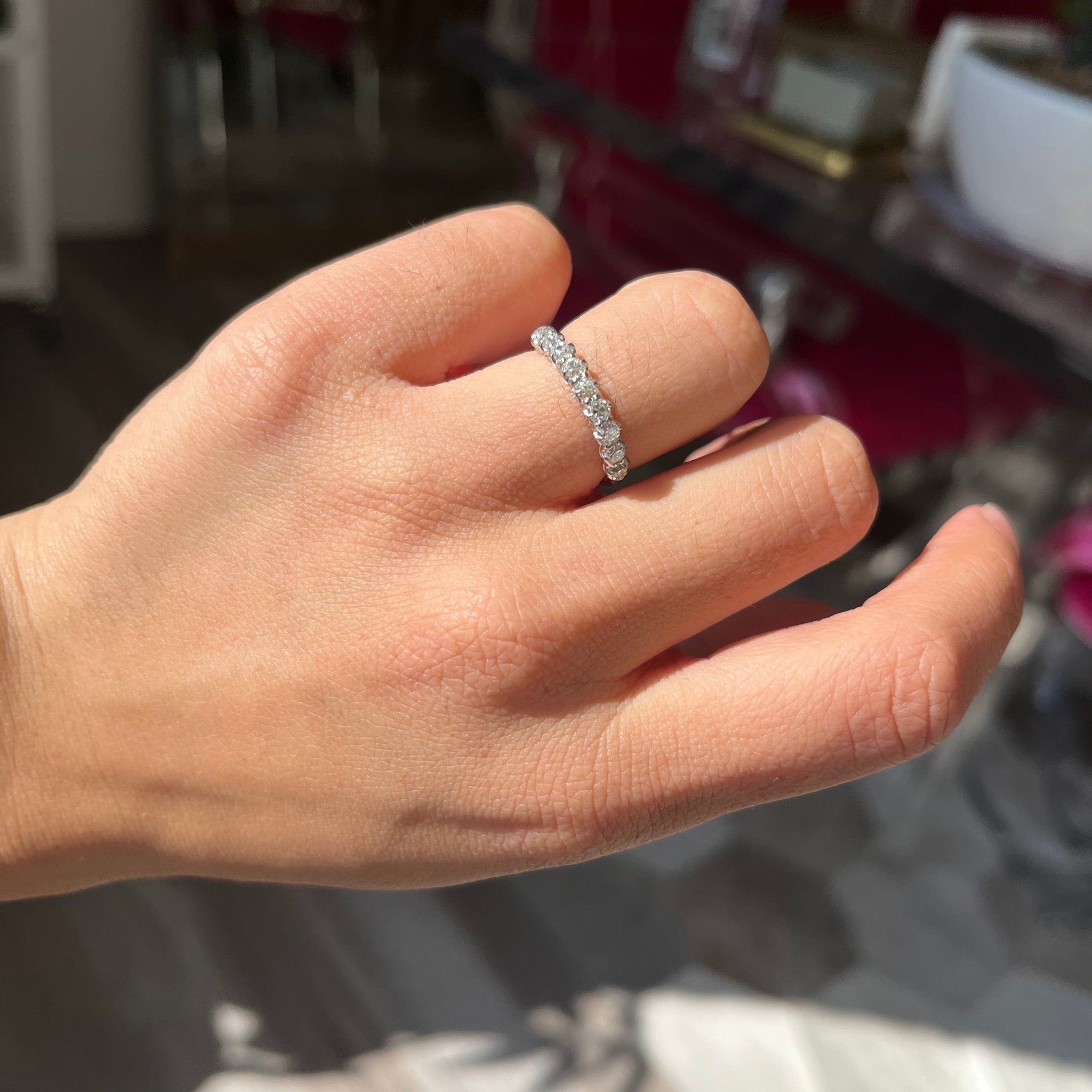 Elegant .77ctw Petite Old Mine Cut Diamond Half-Hoop Band, romantic design with Old Mine Cut Diamonds, Earth-mined diamonds in platinum shown on ring finger
