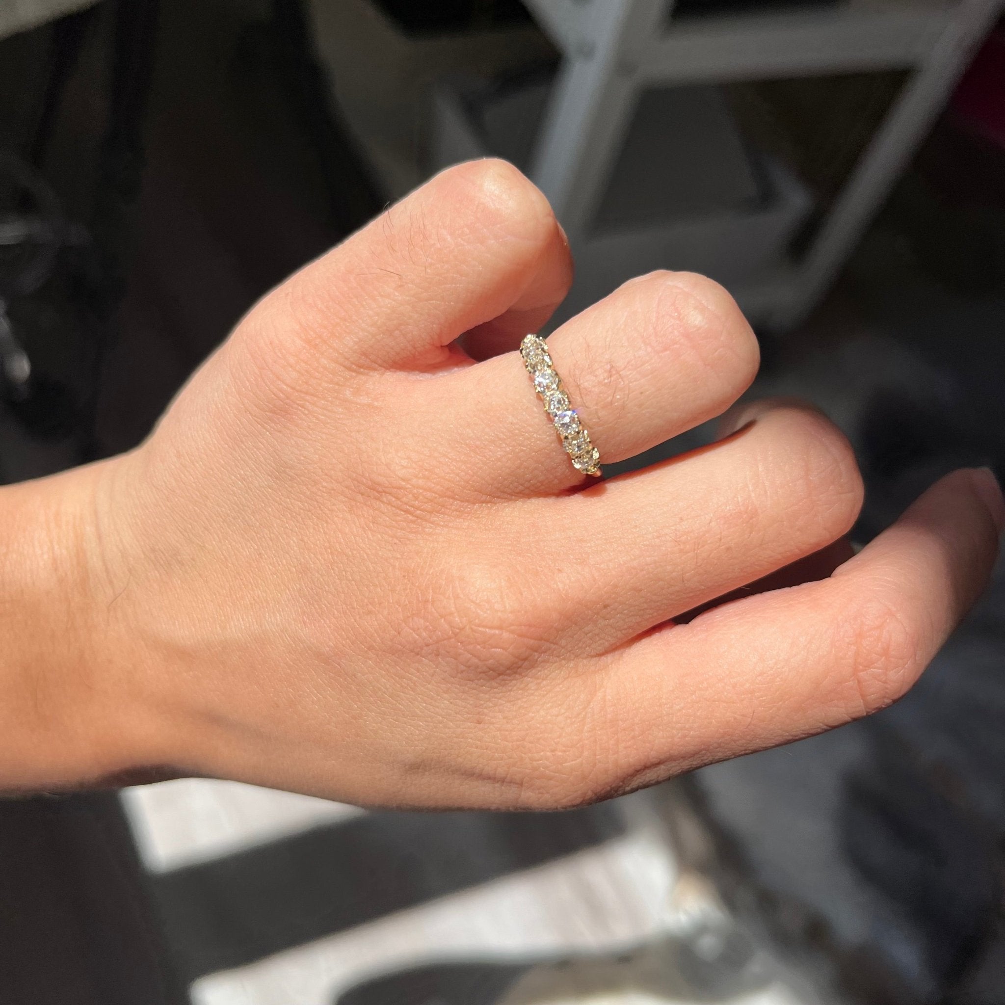 Elegant .77ctw Petite Old Mine Cut Diamond Half-Hoop Band, romantic design with Old Mine Cut Diamonds, Earth-mined diamonds in yellow gold shown on ring finger