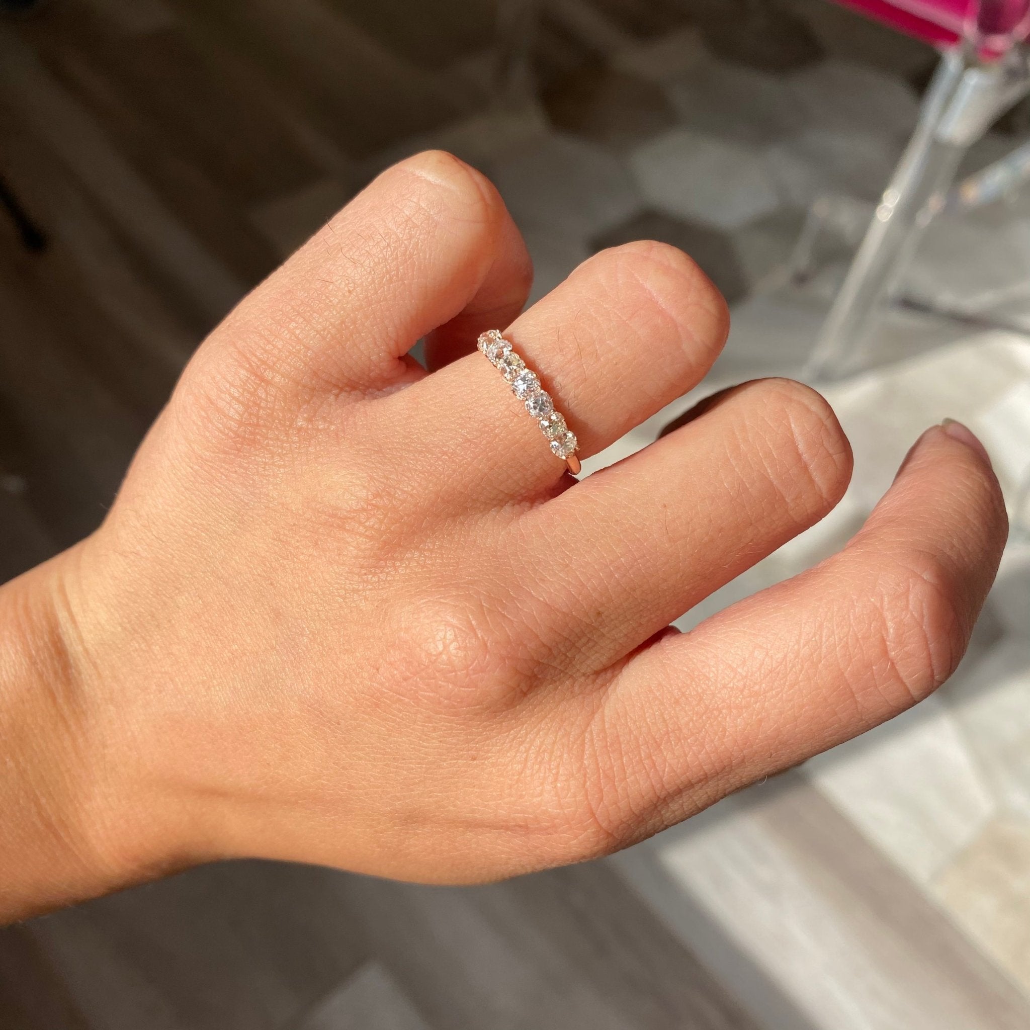 Elegant .82ctw Petite Old Mine Cut Diamond 7-Stone Band, romantic design with Old Mine Cut Diamonds, Earth-mined diamonds in rose gold shown on ring finger