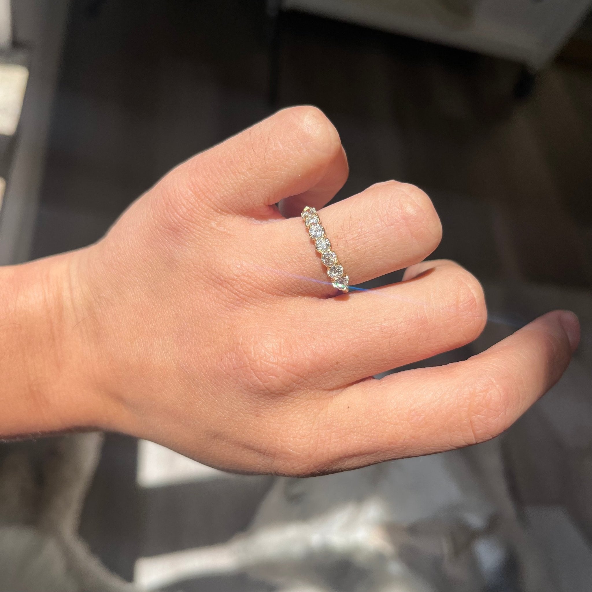 Elegant .83ctw Old European Cut Diamond Half-Hoop Band, romantic design with Old European Cut Diamonds, Earth-mined diamonds in yellow gold shown on ring finger
