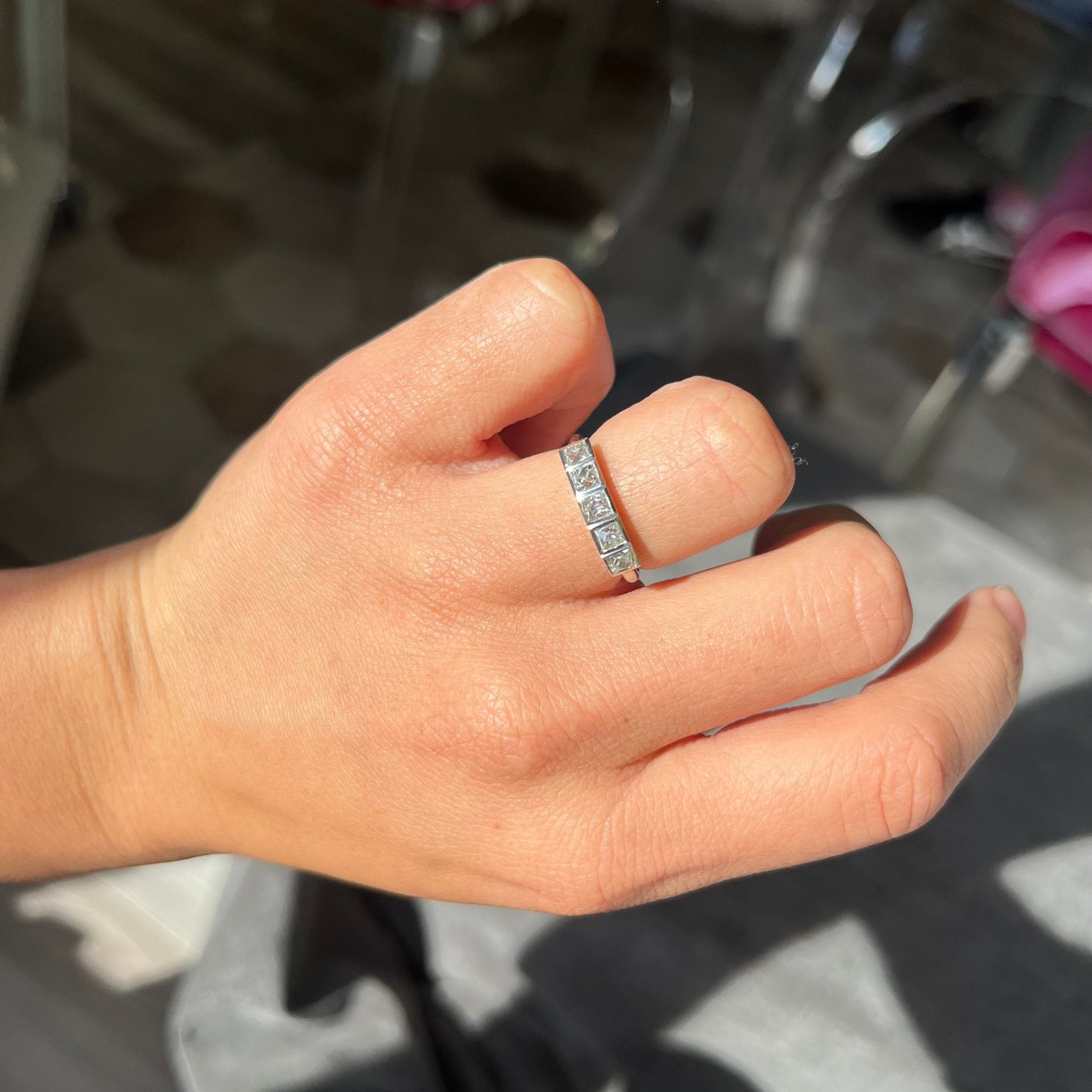 Elegant .85ctw French Cut Diamond 5-Stone Bezel Band, romantic design with French Cut Diamonds, Earth-mined diamonds in platinum shown on ring finger