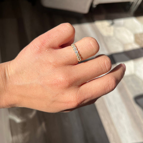 Elegant .86ctw Petite Old Mine Cut Diamond 7-Stone Band, romantic design with Old Mine Cut Diamonds, Earth-mined diamonds in yellow gold shown on ring finger