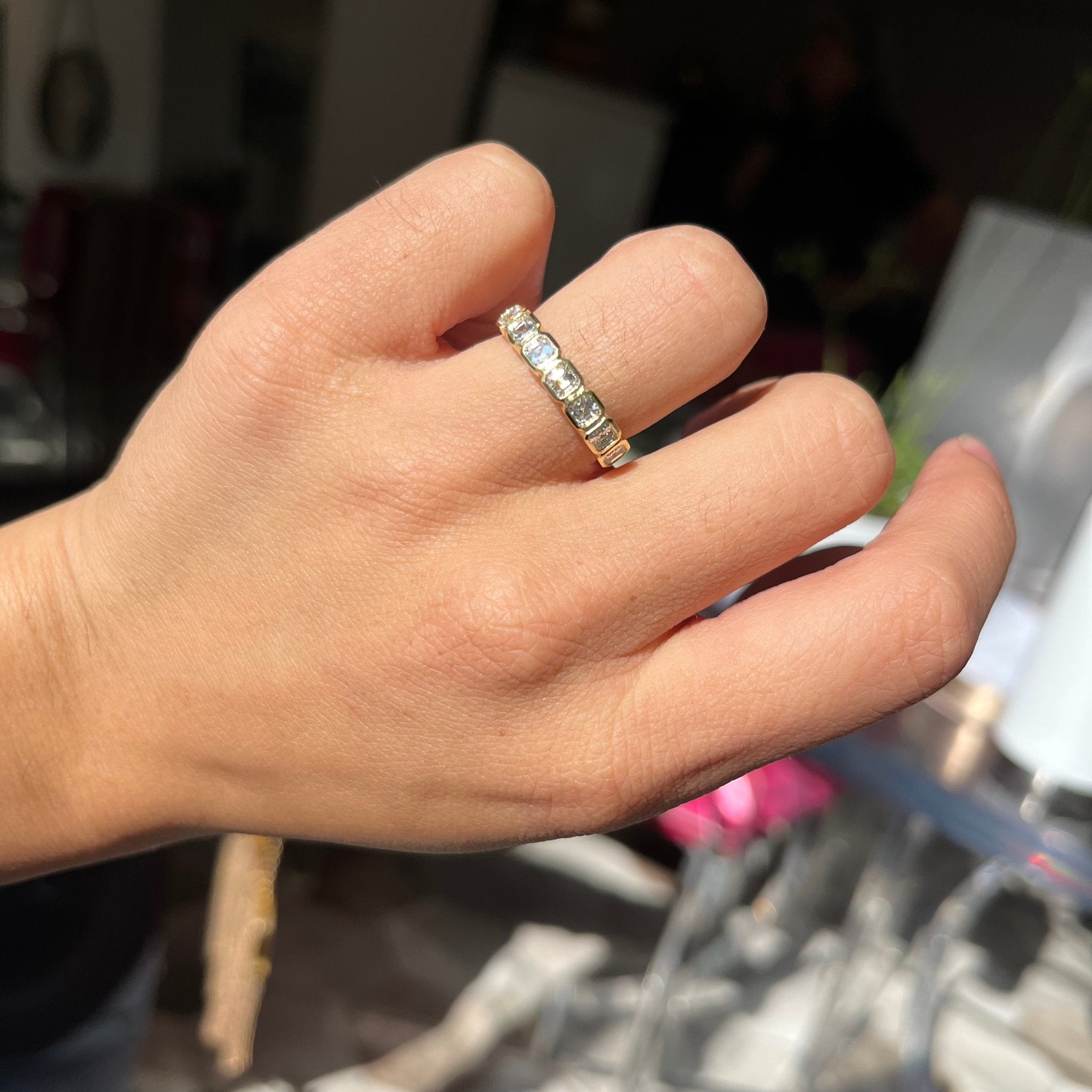 Elegant .87ctw Asscher Cut Diamond Bezel Half-Hoop Band, romantic design with Antique Diamonds, Earth-mined diamonds in yellow gold shown on ring finger