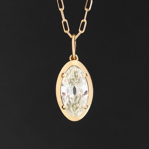 Vintage marquise cut diamond pendant necklace set in north–south orientation with 14k yellow gold chain.