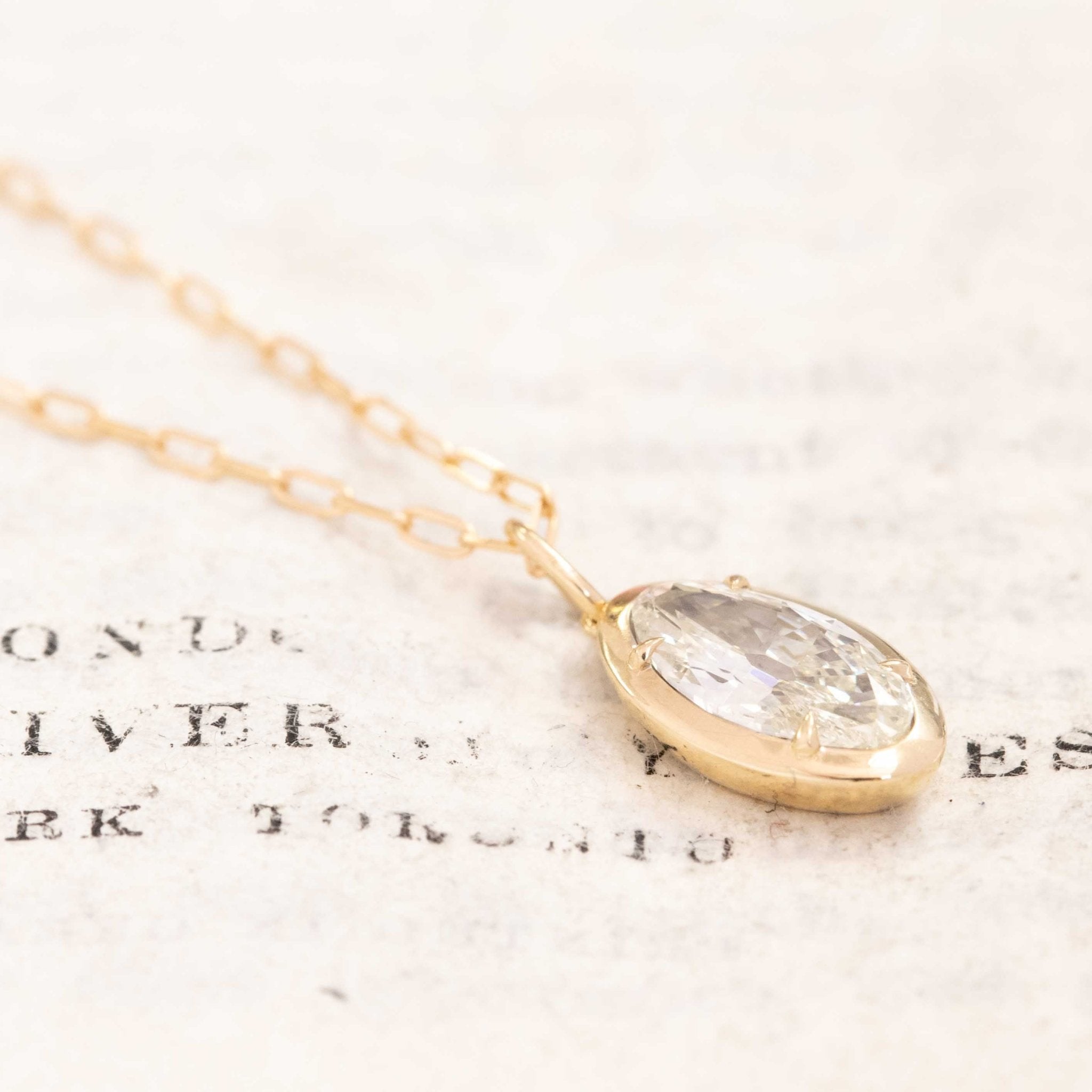 Vintage yellow gold pendant with marquise cut diamond featuring chunky facets and open culet.