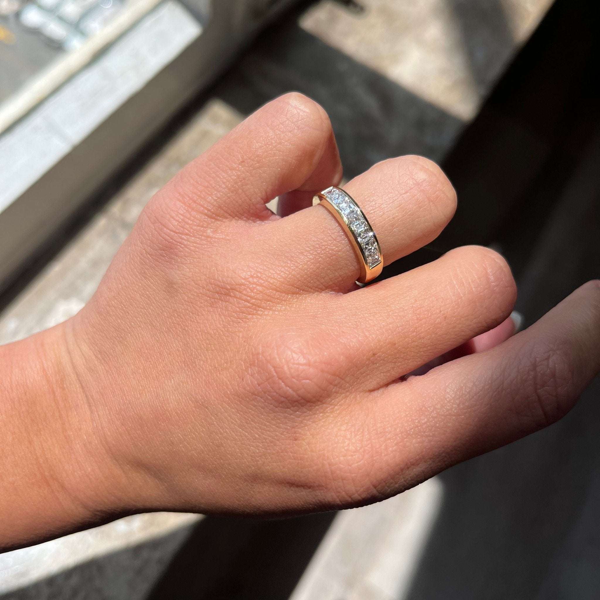 Elegant .89ctw Asscher Cut Diamond Channel Band, romantic design with Antique Diamonds, Earth-mined diamonds in yellow gold shown on ring finger