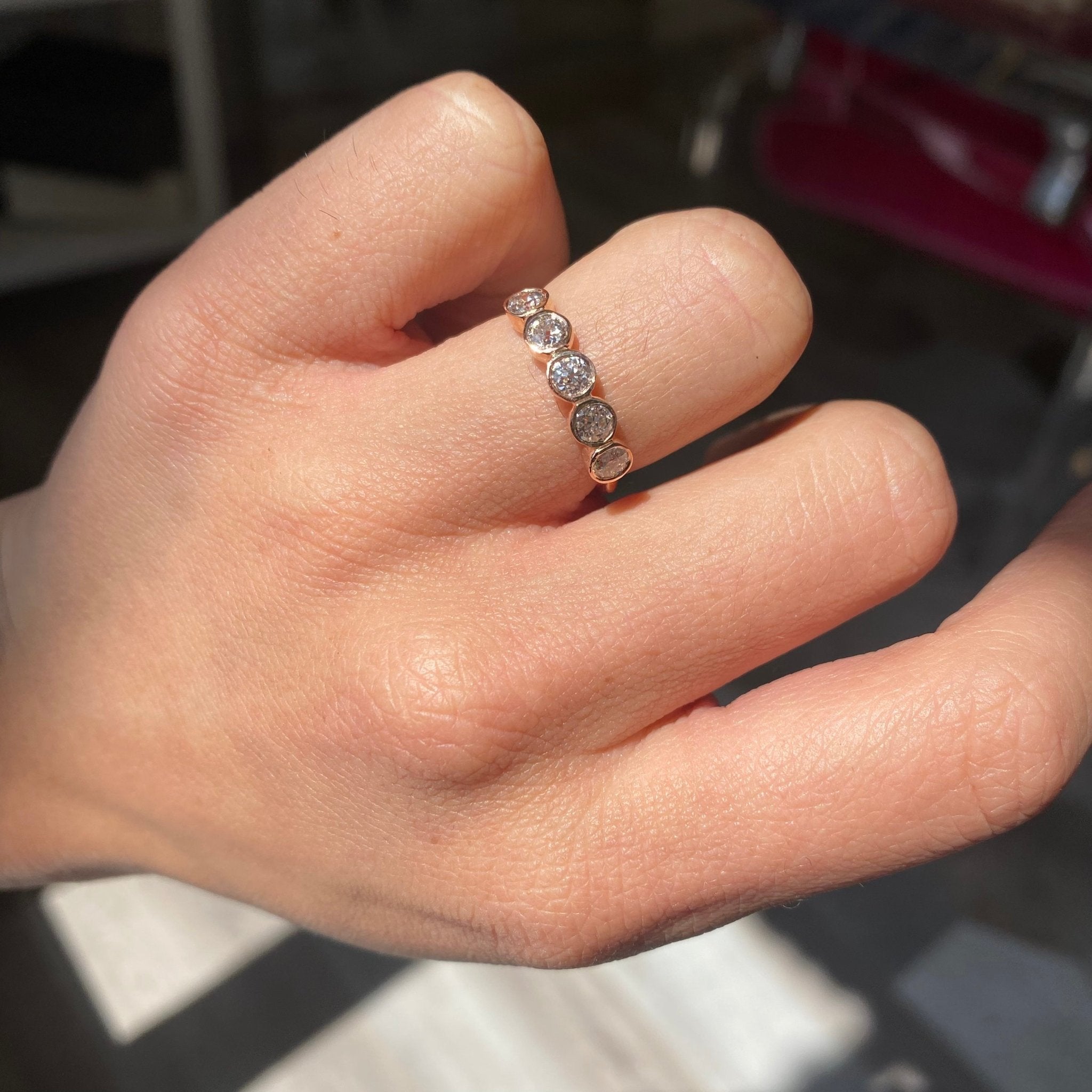 Elegant .89ctw Old European Cut Diamond 5-Stone Bezel Band, romantic design with Old European Cut Diamonds, Earth-mined diamonds in rose gold shown on ring finger