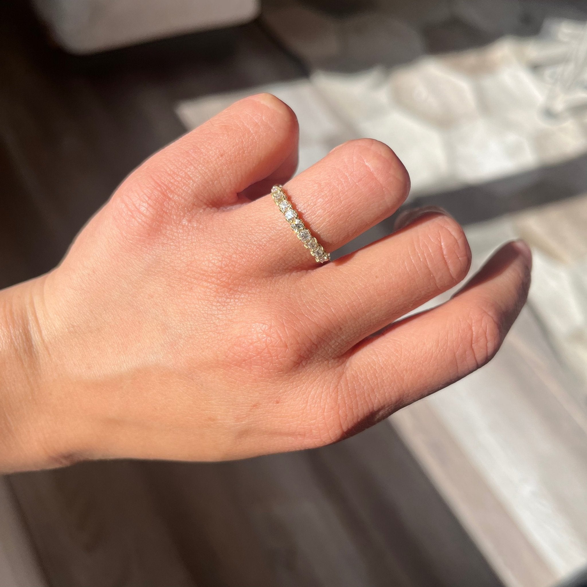 Elegant .89ctw Old Mine Cut Diamond Half-Hoop Band, romantic design with Old Mine Cut Diamonds, Earth-mined diamonds in yellow gold shown on ring finger
