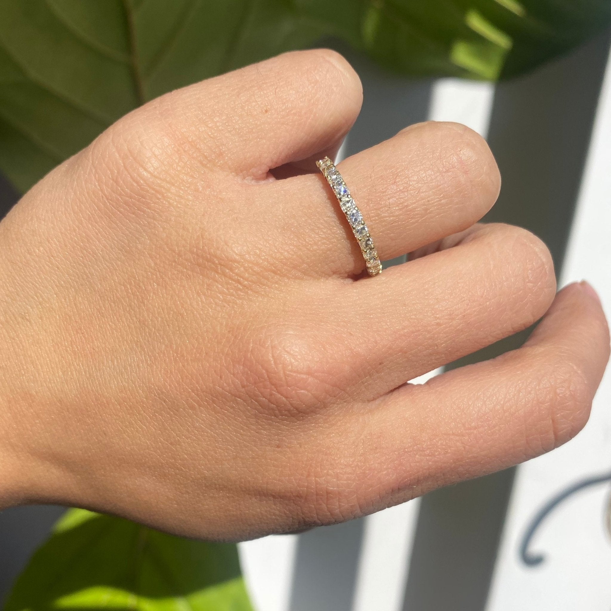 Elegant .90ctw Petite Old Mine Cut Diamond Half-Eternity Band, romantic design with Old Mine Cut Diamonds, Earth-mined diamonds in yellow gold shown on ring finger