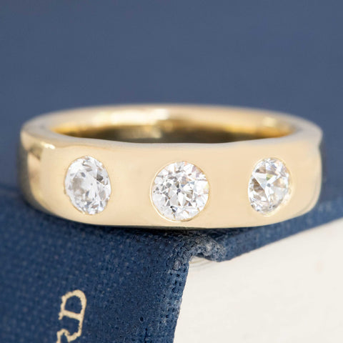 0.92ctw old European cut diamond flush set 3-stone band, 18K yellow gold