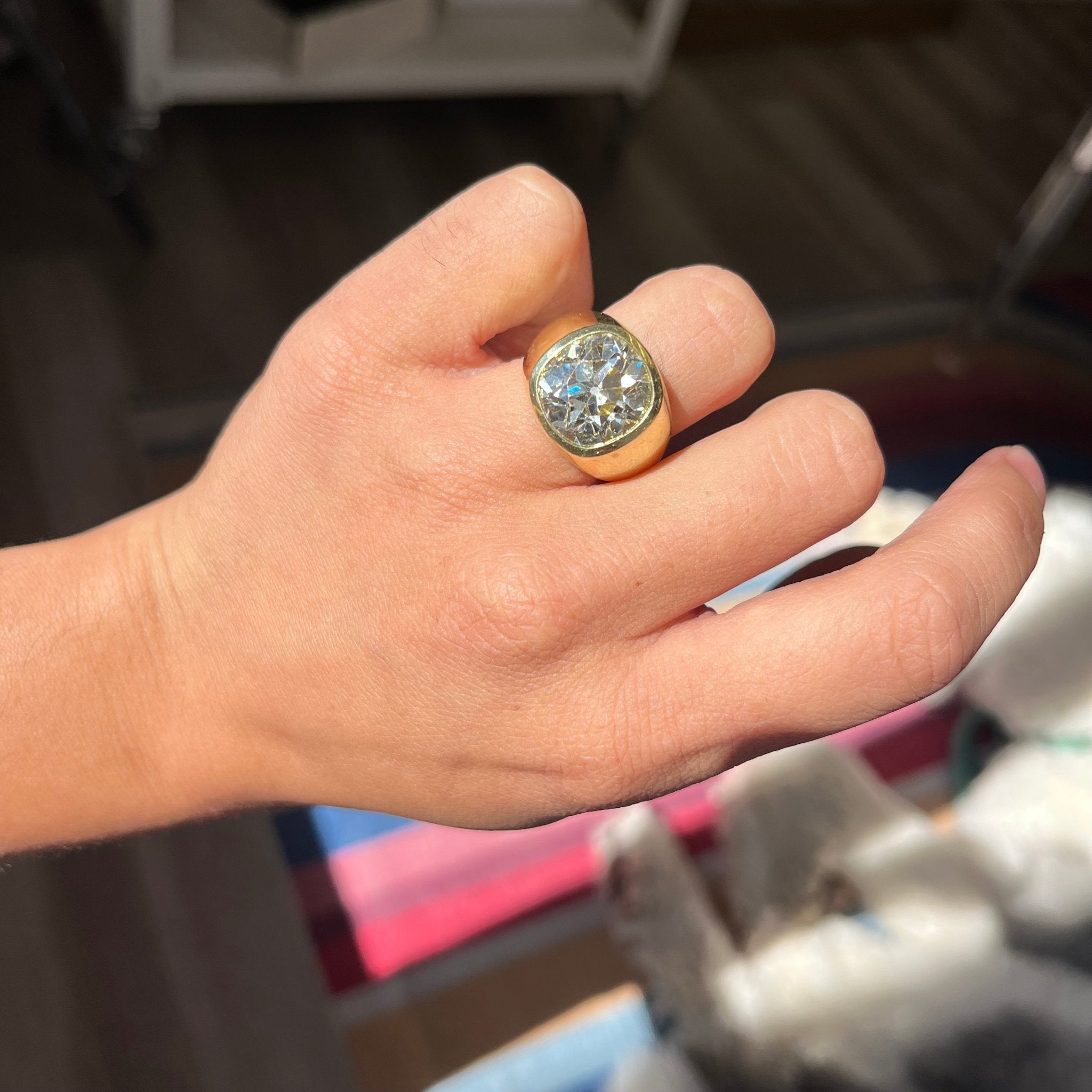 Antique engagement ring featuring 9.33ct old mine cut diamond in chunky bezel setting, vintage heirloom style shown on the finger