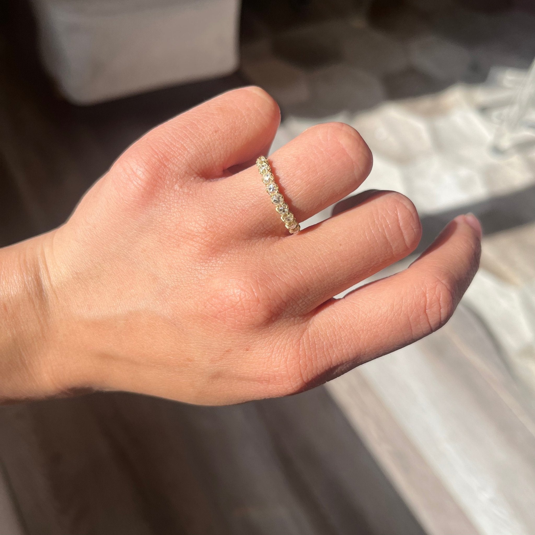 Elegant .93ctw Old Mine Cut Diamond Half-Hoop Band, romantic design with Old Mine Cut Diamonds, Earth-mined diamonds in yellow gold shown on ring finger