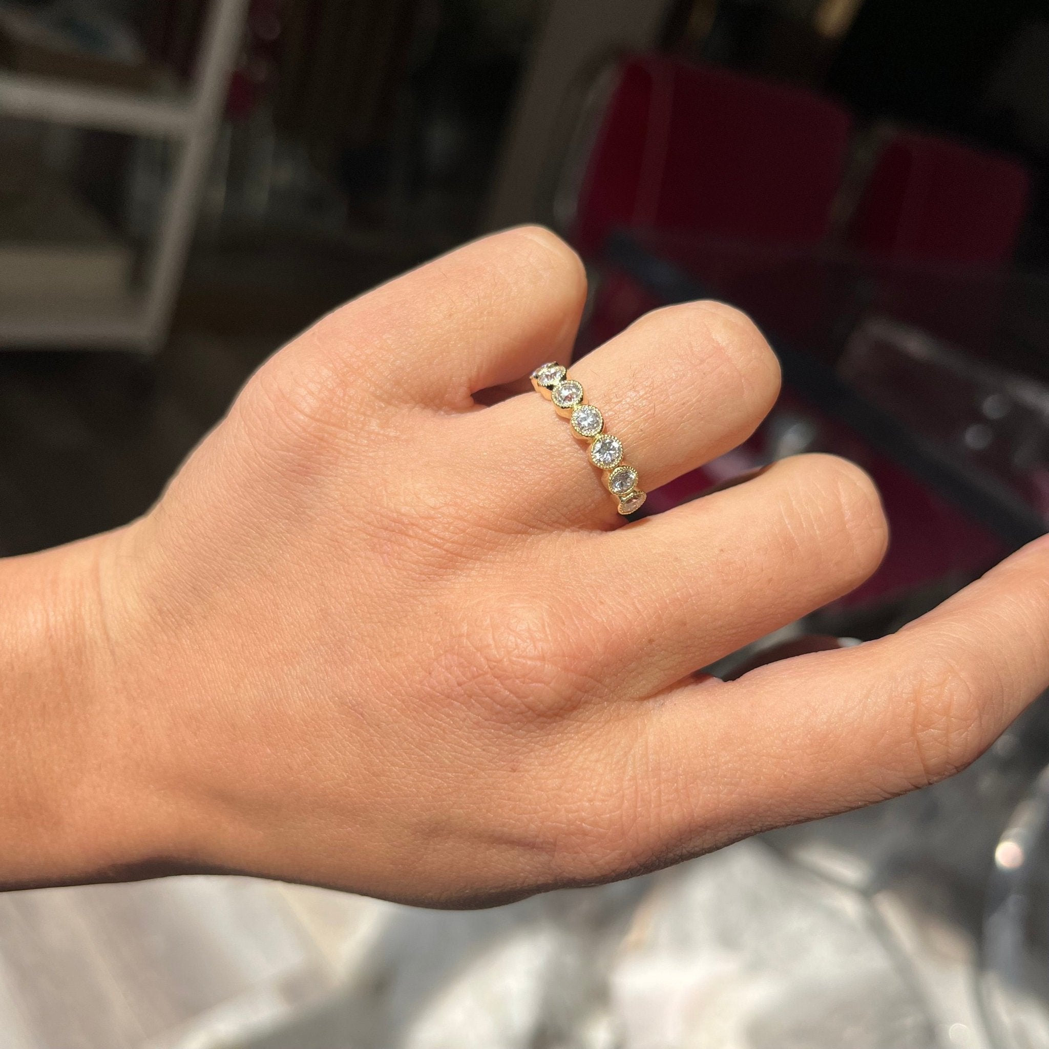 .94ctw Petite Old European Cut Diamond Half-Hoop Bezel Band with Old European Cut Diamonds in yellow gold, antique-inspired one-of-a-kind wedding band shown on ring finger