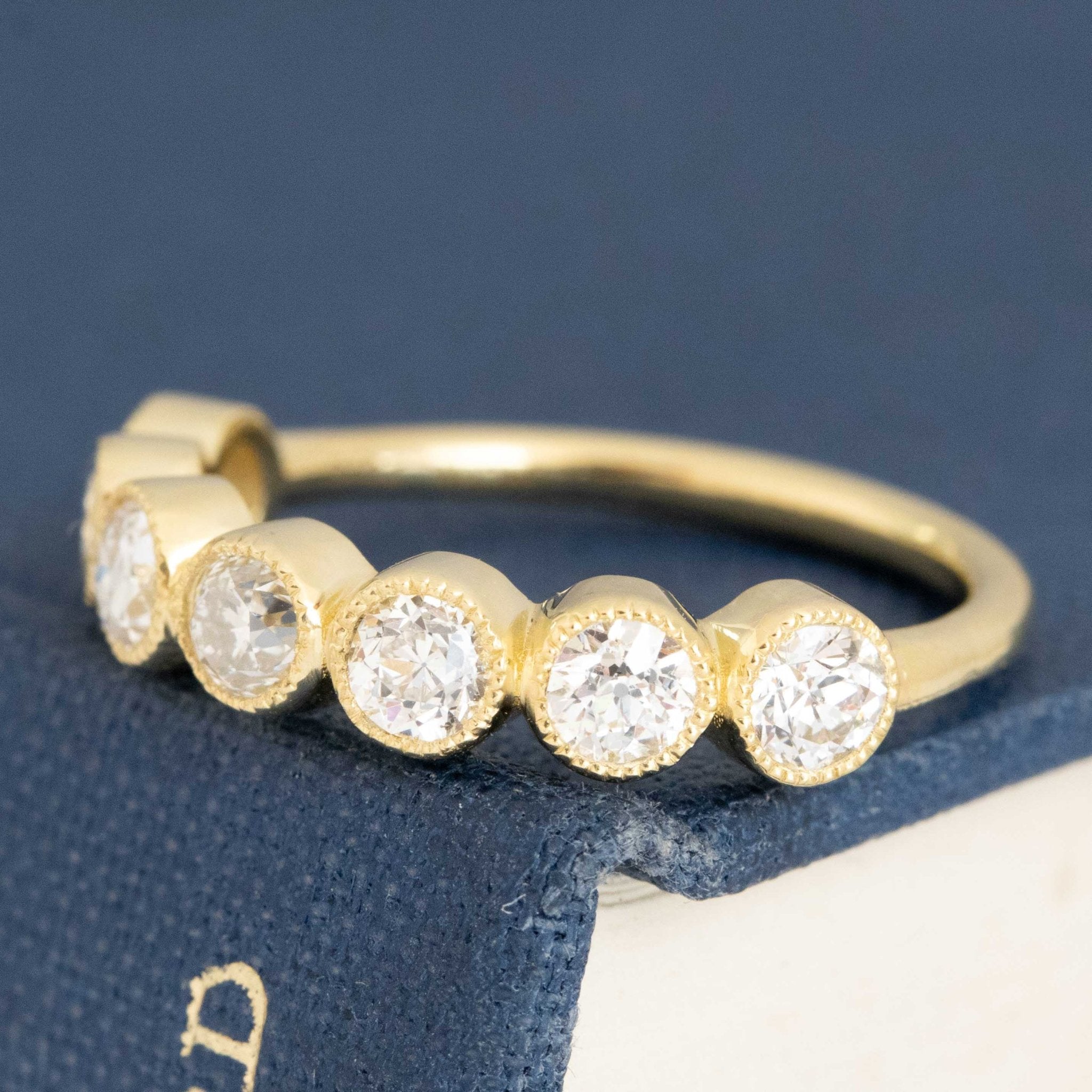 Antique lovers’ .94ctw Petite Old European Cut Diamond Half-Hoop Bezel Band in yellow gold, featuring rare Earth-mined Old European Cut Diamonds