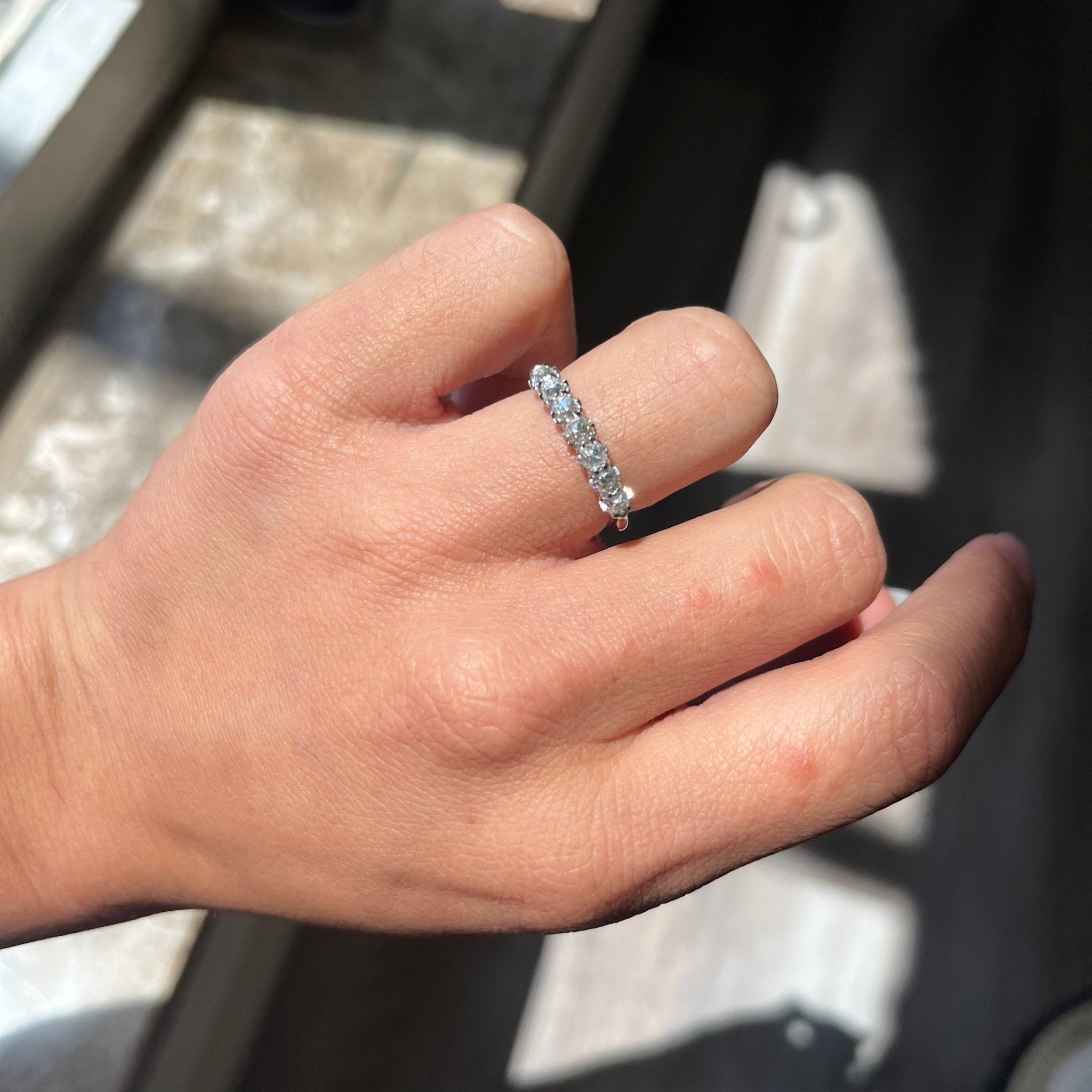 Elegant .95ctw Old Mine Cut Diamond 7-Stone Half-Hoop Band, romantic design with Old Mine Cut Diamonds, Earth-mined diamonds in platinum shown on ring finger