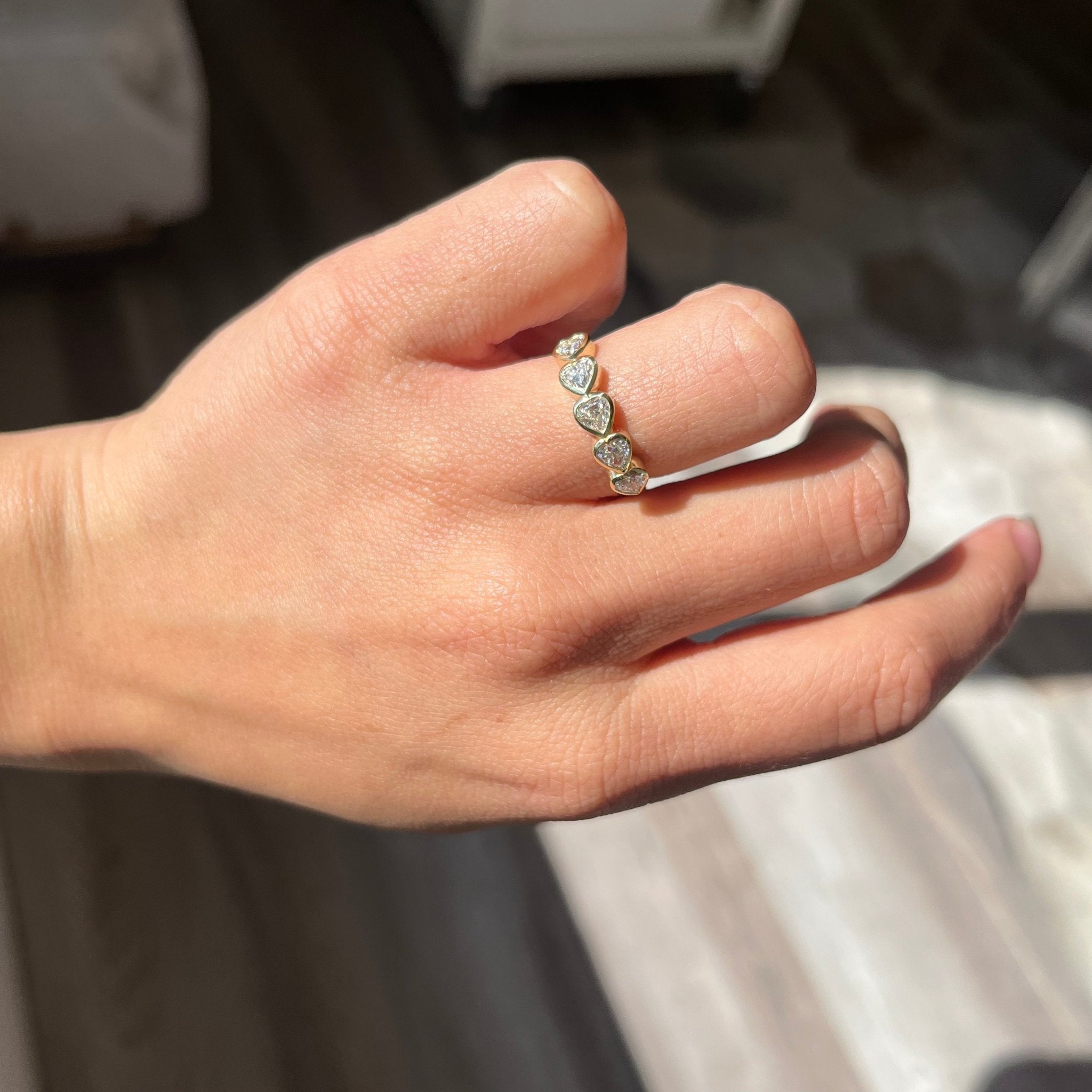Elegant .96ctw Heart Cut Diamond Bezel 5-Stone Band, romantic design with Antique Diamonds, Earth-mined diamonds in yellow gold shown on ring finger