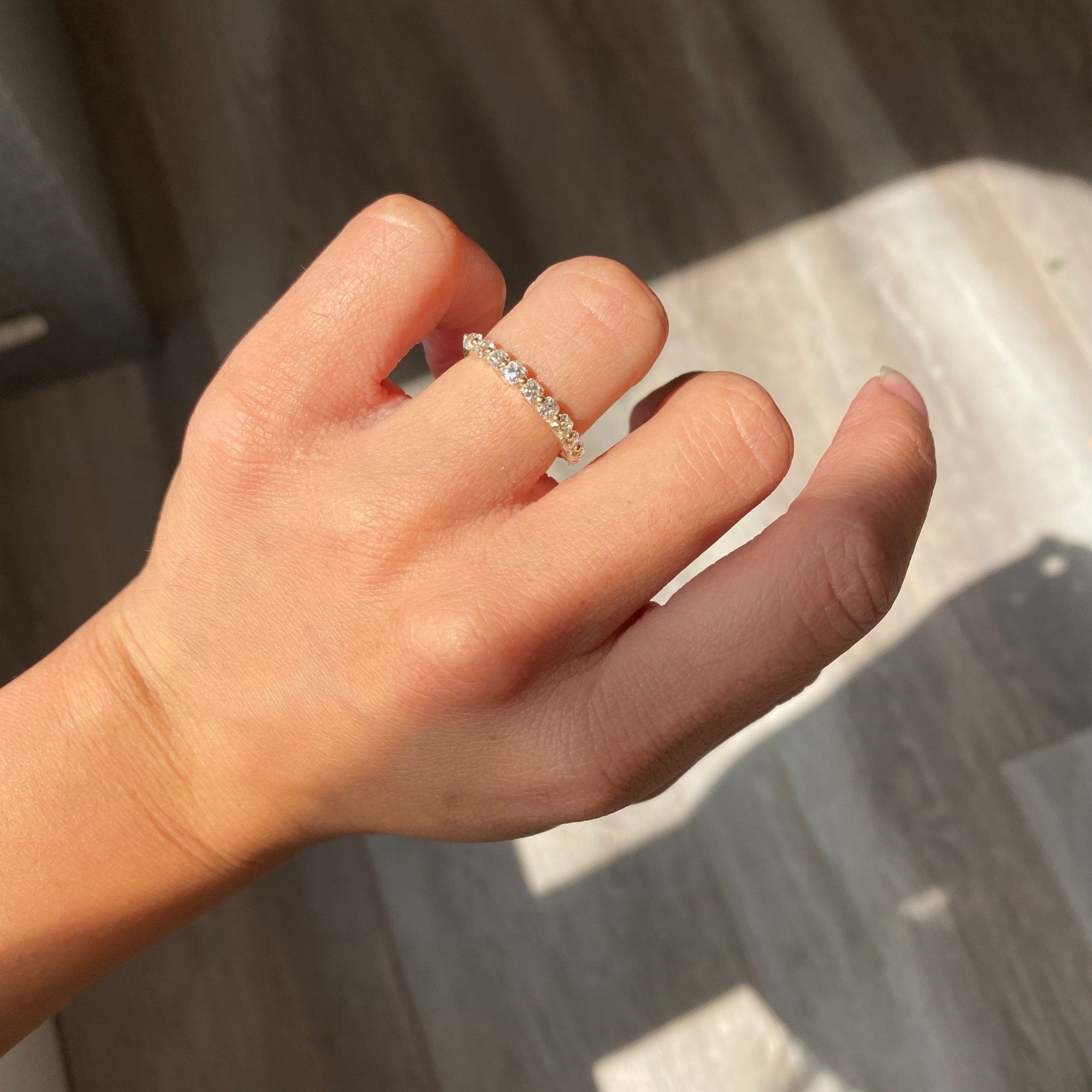 Elegant .97ctw Old Mine Cut Diamond Shared Prong Half-Hoop Band, romantic design with Old Mine Cut Diamonds, Earth-mined diamonds in yellow gold shown on ring finger