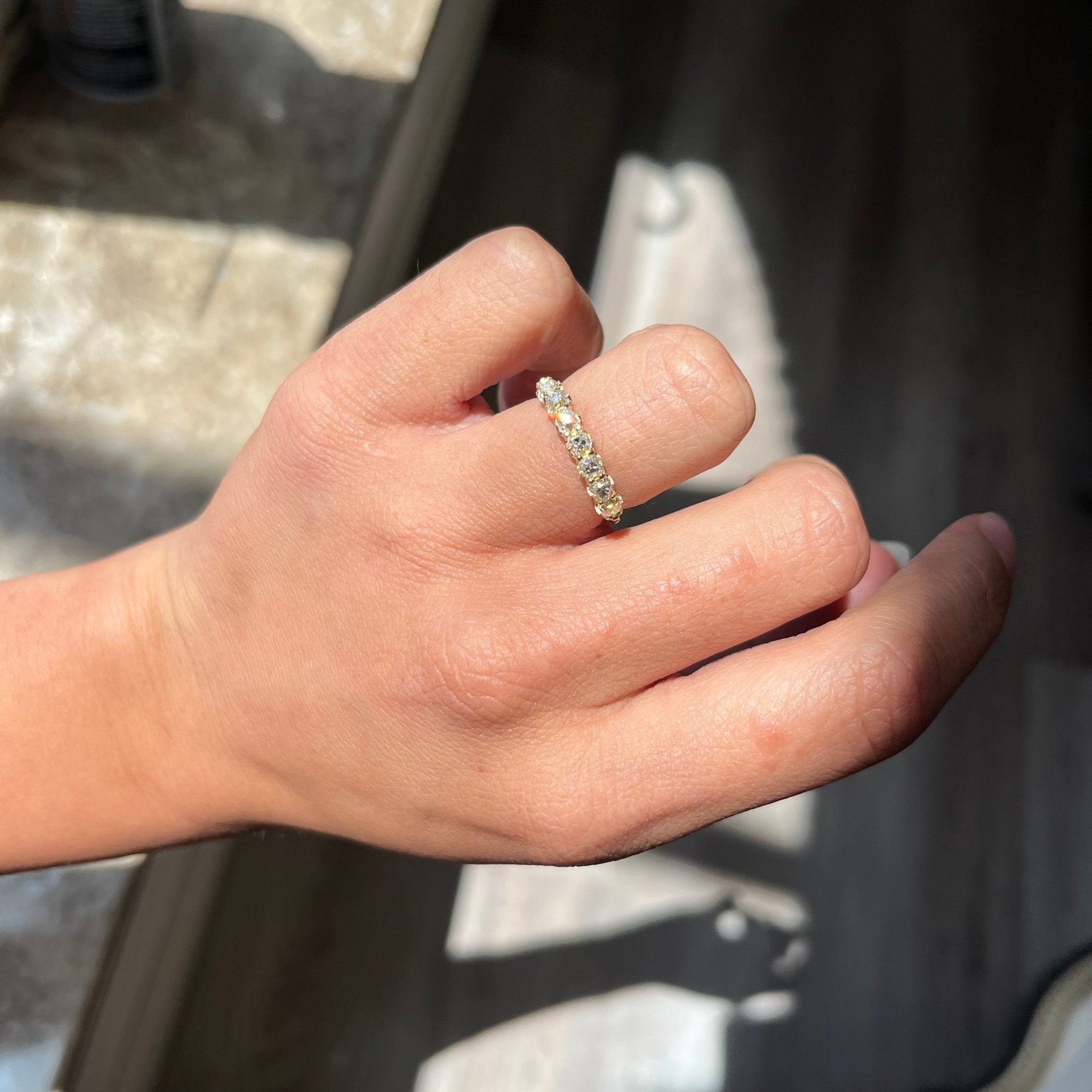 Elegant .99ctw Old Mine Cut Diamond 7-Stone Half-Hoop Band, romantic design with Old Mine Cut Diamonds, Earth-mined diamonds in yellow gold shown on ring finger