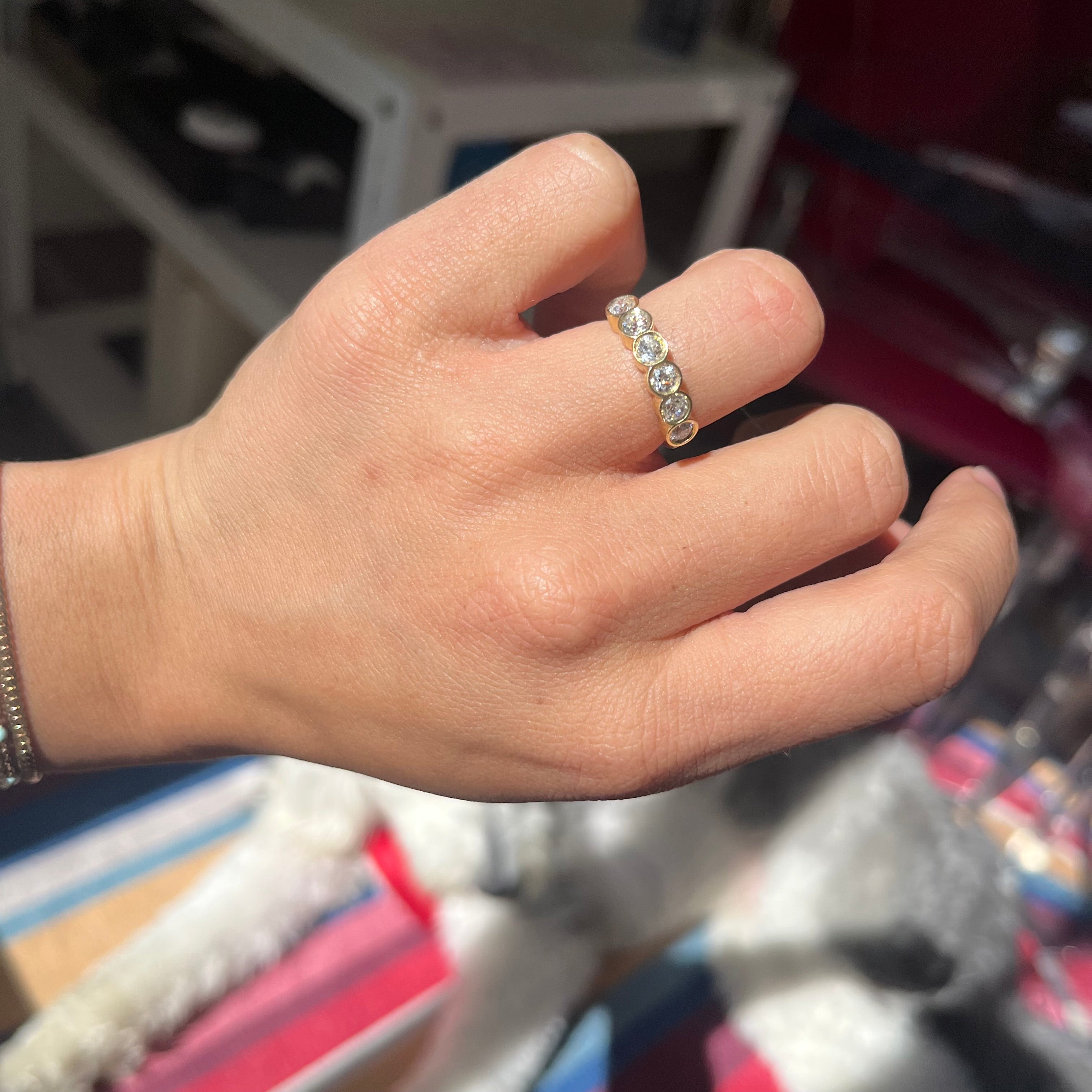 Elegant .52ctw Old European Cut Diamond 6-Stone Bezel Band, romantic design with Old European Cut Diamonds, Earth-mined diamonds in yellow gold shown on ring finger.