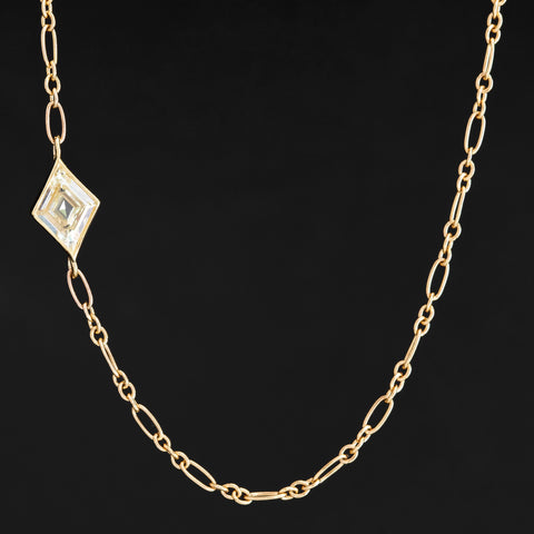 Kite-shaped diamond necklace set in 18k yellow gold bezel, stationed off-center on 14k Italian chain.