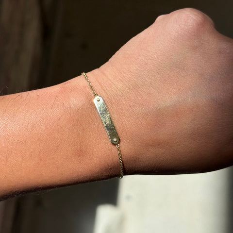 Vintage gold Petite ID Bracelet by Tiffany & Co shown on a person's wrist.