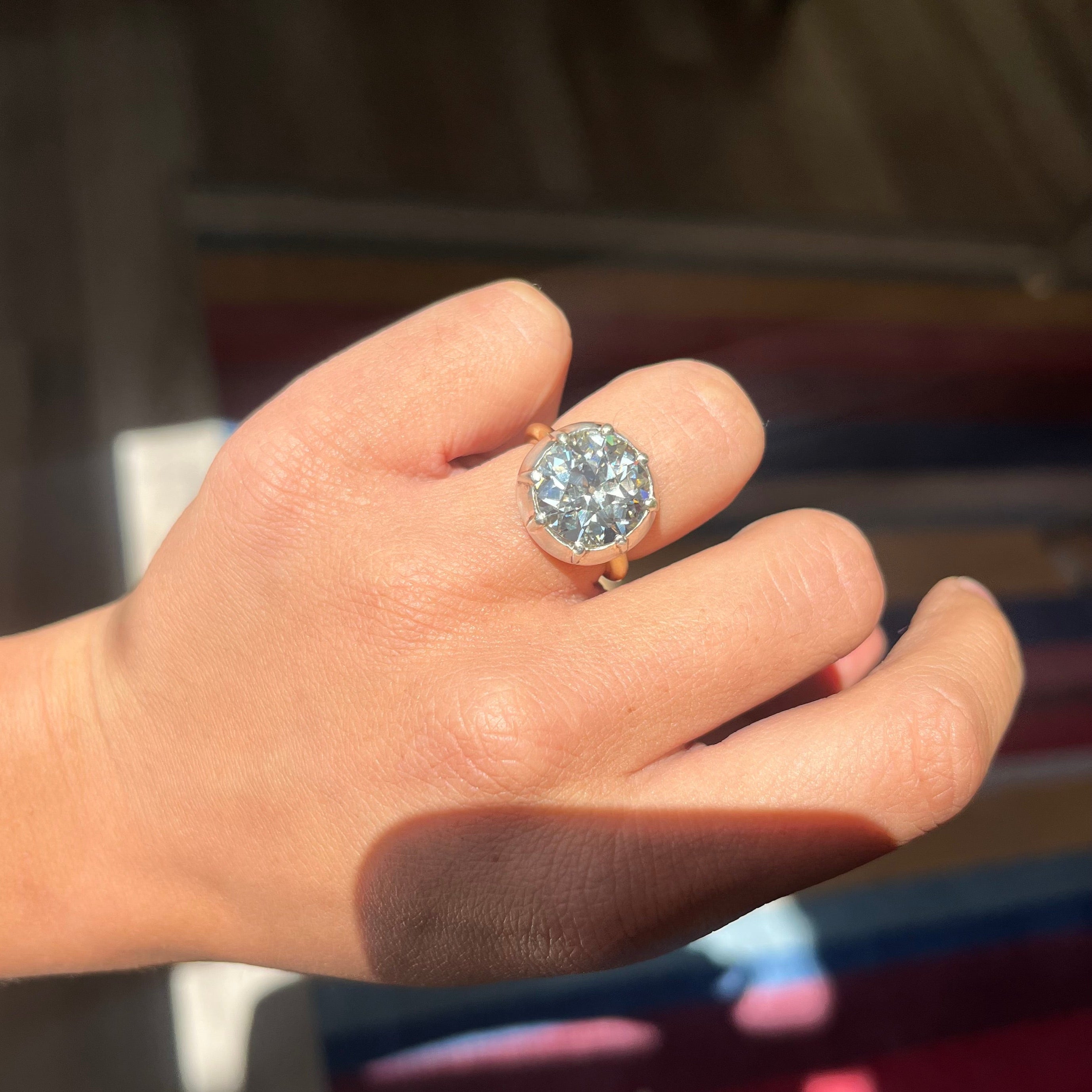 Hand shot of the 6.42ct old European cut diamond in a vintage inspired collet setting in silver and 18kt yellow gold. A beautiful vintage diamond and/or vintage engagement ring choice!