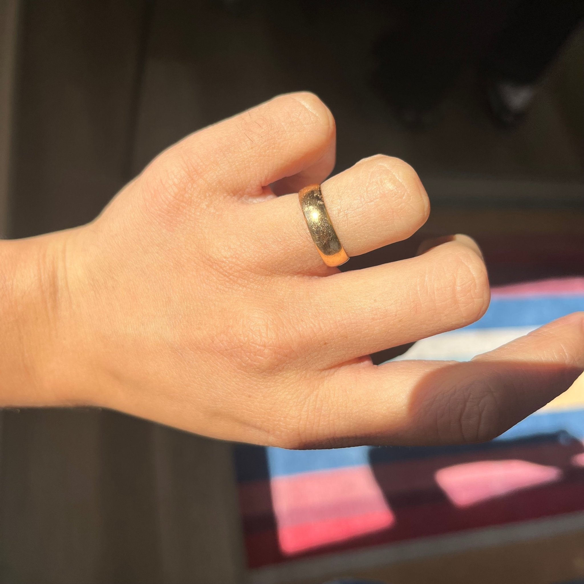 hand shot of Vintage 22kt gold wedding ring, handcrafted with classic detailing.