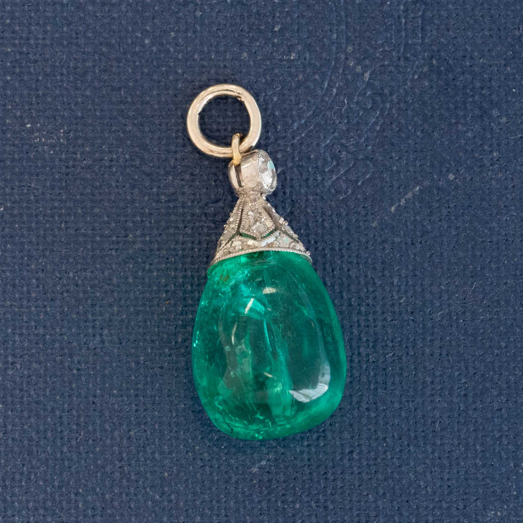 An antique Colombian emerald bead pendant with a beautiful, rich, and desirable color. Strung on an antique component with diamonds.