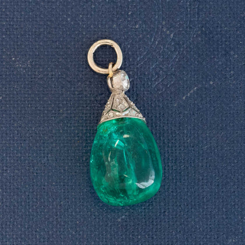 An antique Colombian emerald bead pendant with a beautiful, rich, and desirable color. Strung on an antique component with diamonds.