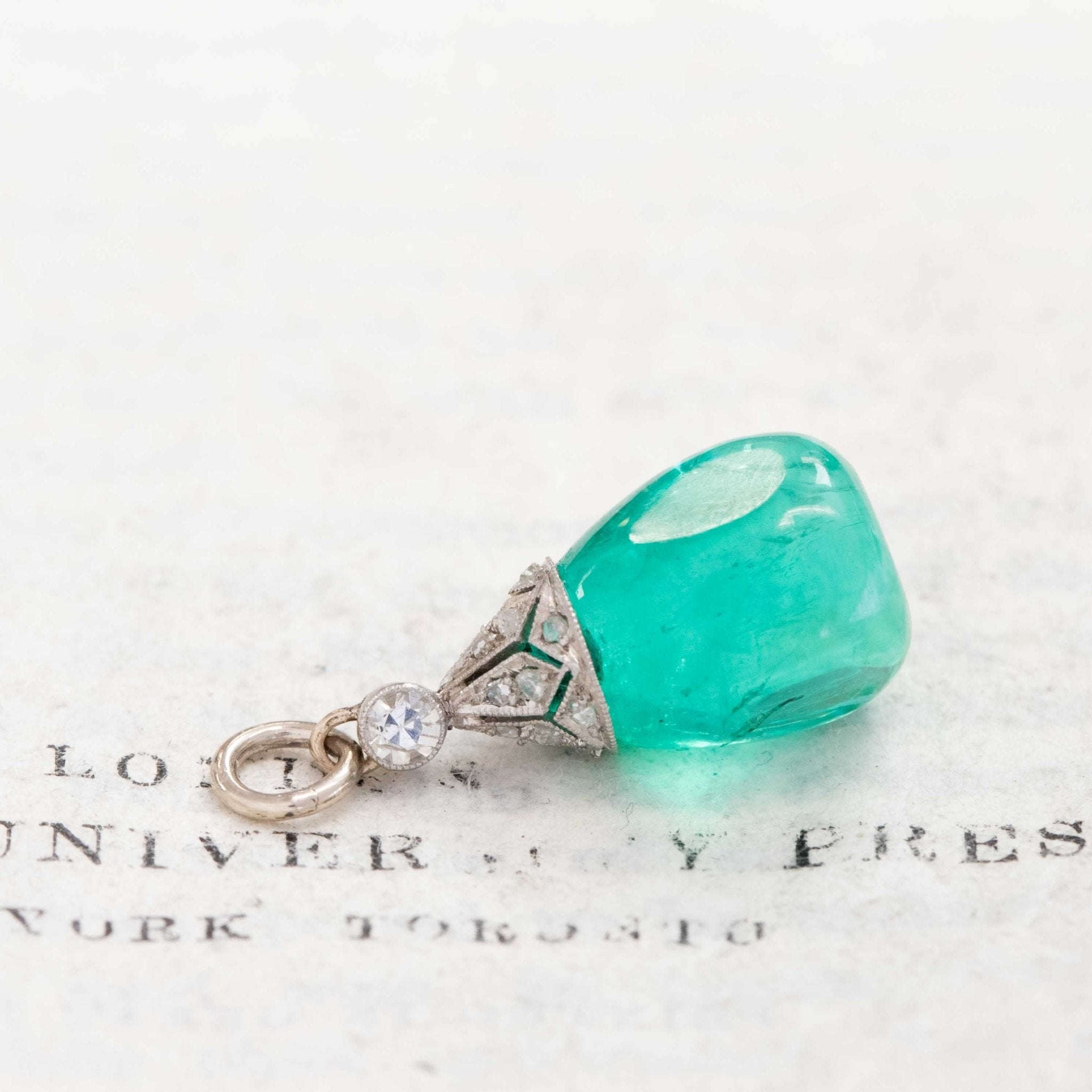An antique Colombian emerald bead pendant with a beautiful, rich, and desirable color. Strung on an antique component with diamonds.