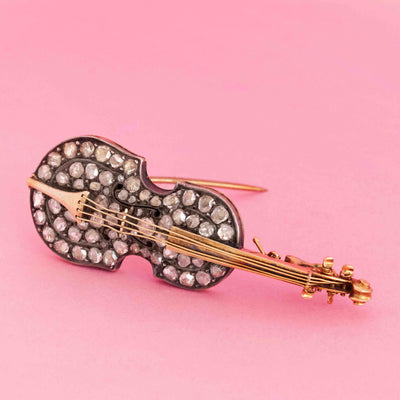 Antique cello brooch pendant with rose cut diamonds in silver-topped 14kt gold on pink background