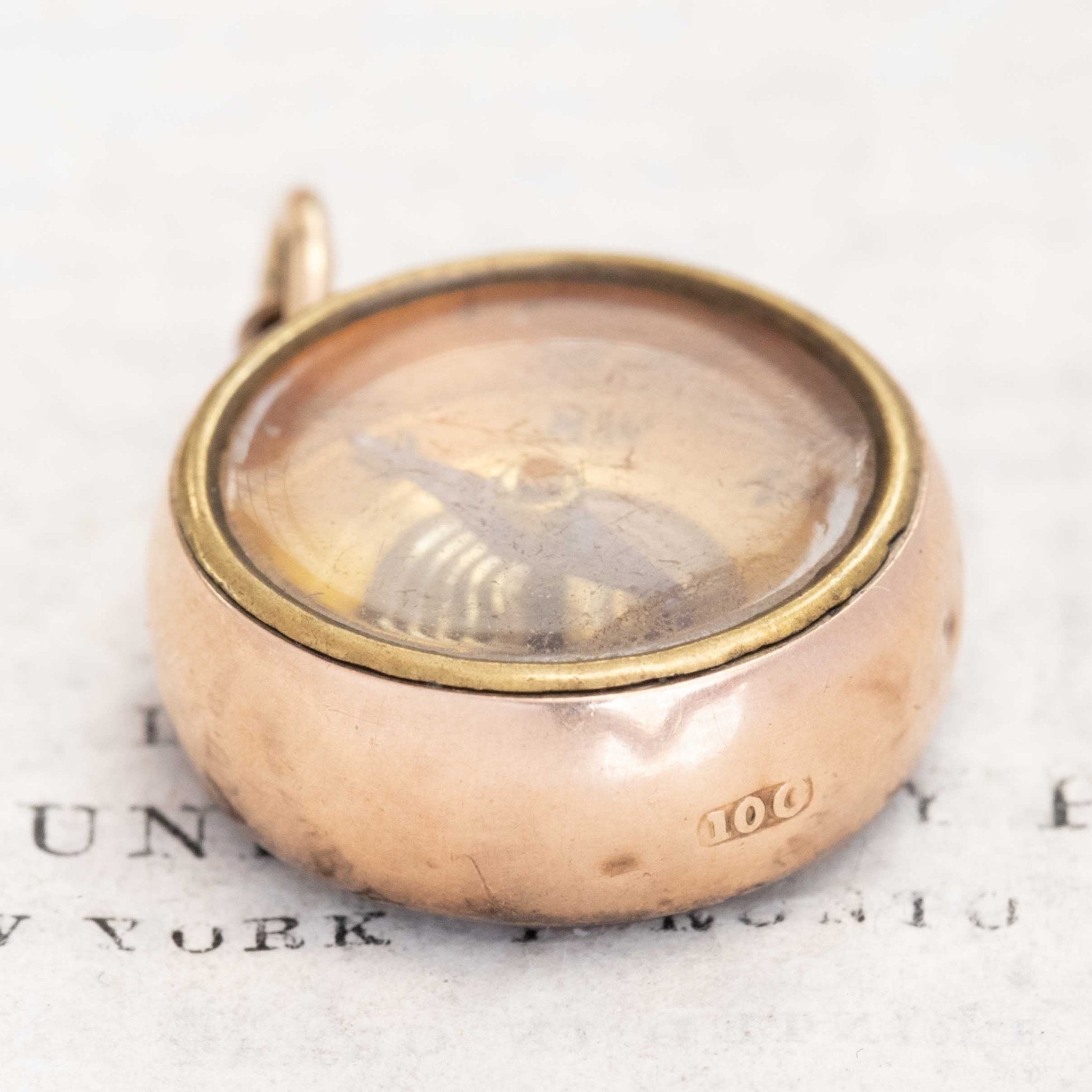 Close-up of compass dial and agate backing in antique pendant
