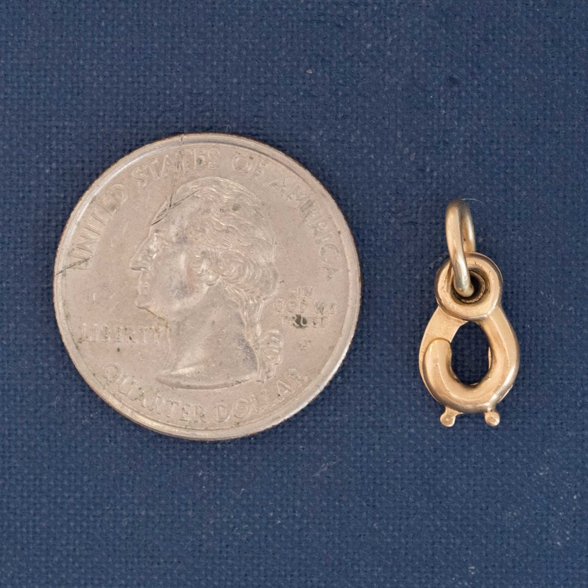 Collectible antique jewelry finding, 18kt gold sister clasp with mirrored hooks, shown next to a quarter for size reference