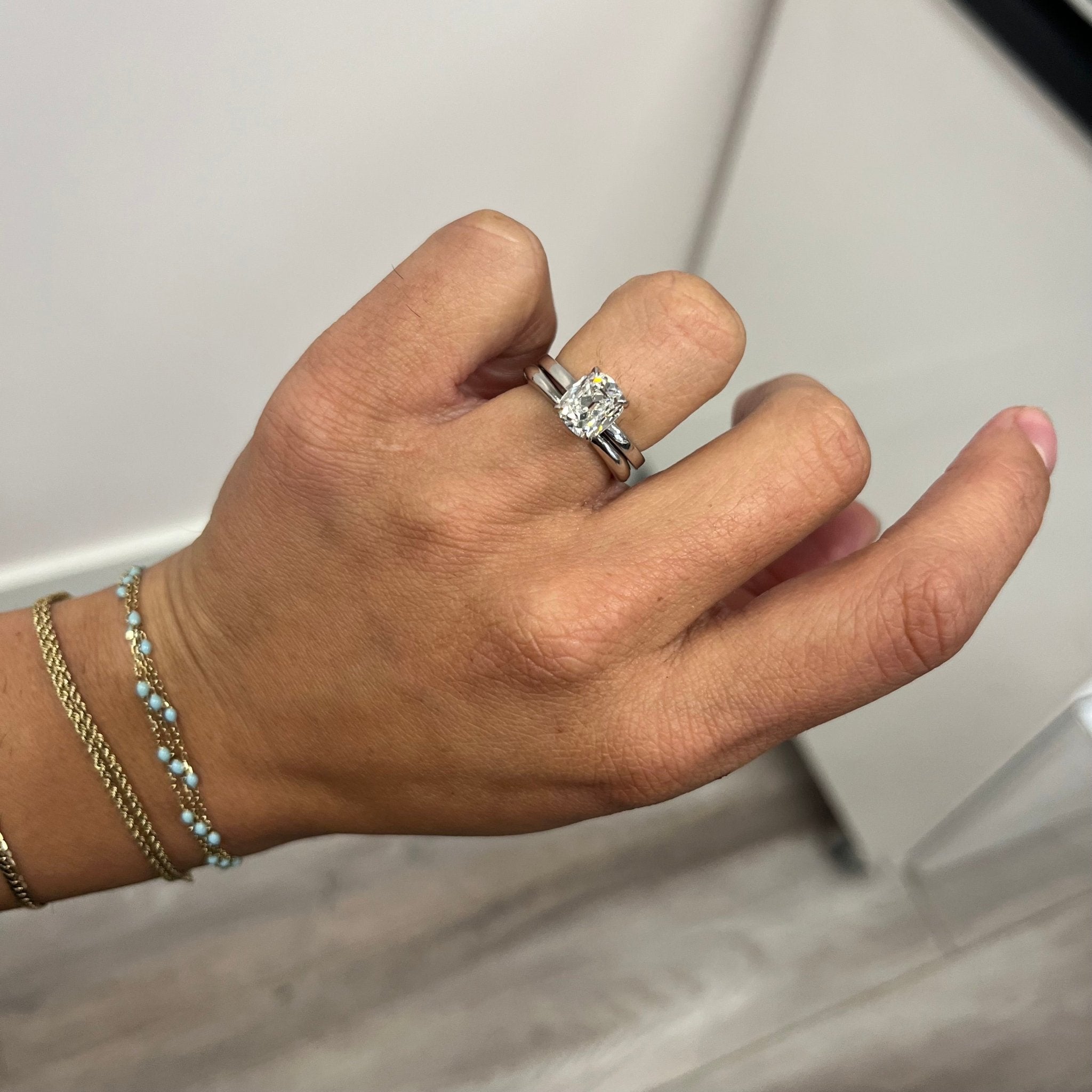 Elegant "Arc" Wedding Band in Platinum, romantic design example stacked with a platinum diamond solitaire.
