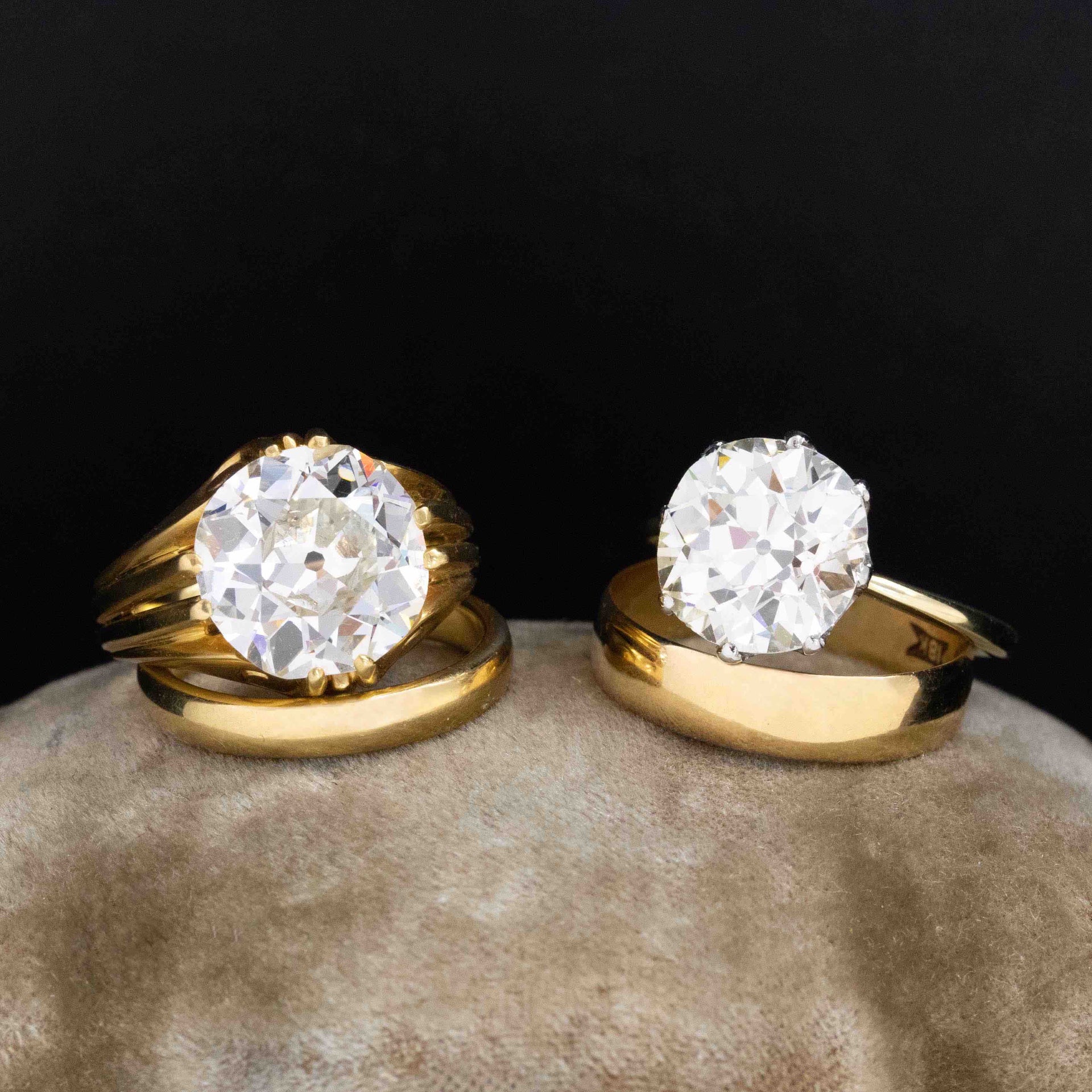Two antique diamond solitaire rings styled with chunky cigar bands